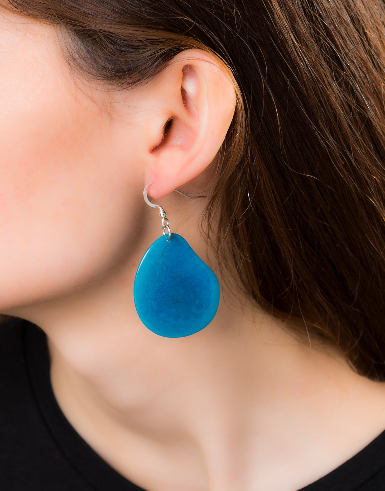 A pair of Folha Tagua Nut Earrings made from vegetable ivory with sterling silver hooks, showcasing unique natural textures and colors.