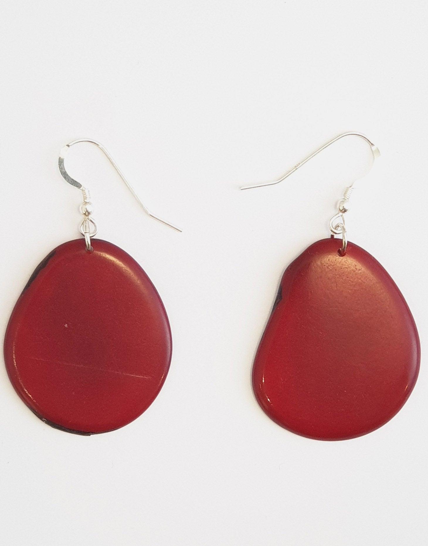 A pair of Folha Tagua Nut Earrings made from vegetable ivory with sterling silver hooks, showcasing unique natural textures and colors.