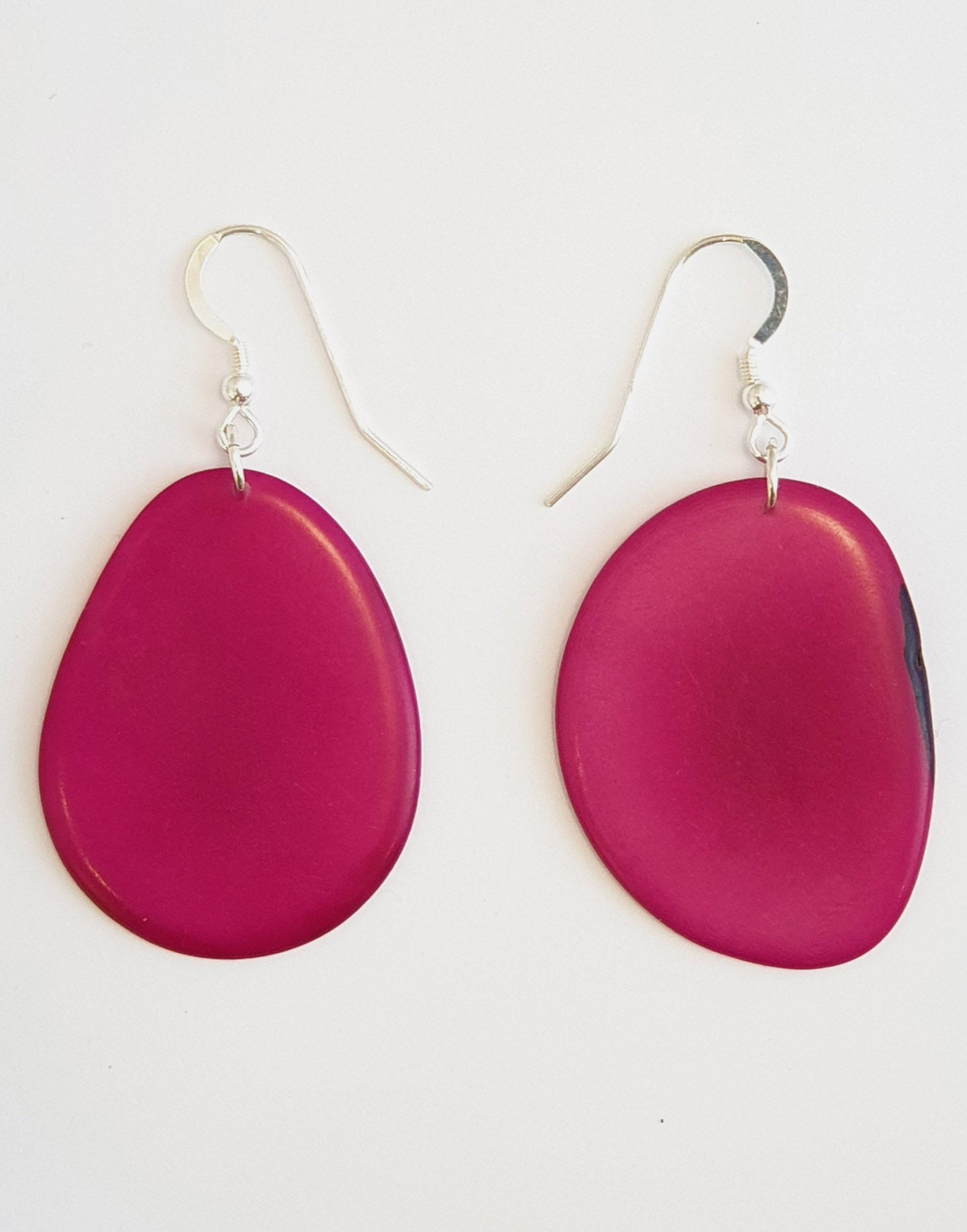 A pair of Folha Tagua Nut Earrings made from vegetable ivory with sterling silver hooks, showcasing unique natural textures and colors.