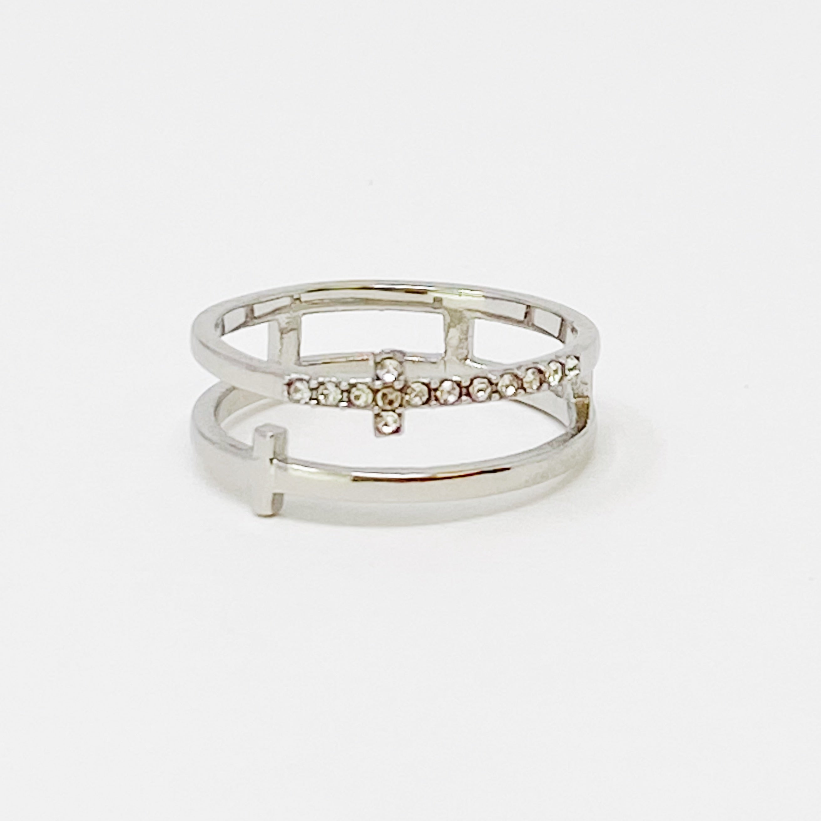 Forever Double Cross Ring featuring gold tone and sparkling Cubic Zirconia stones, elegantly designed with two intertwined crosses.