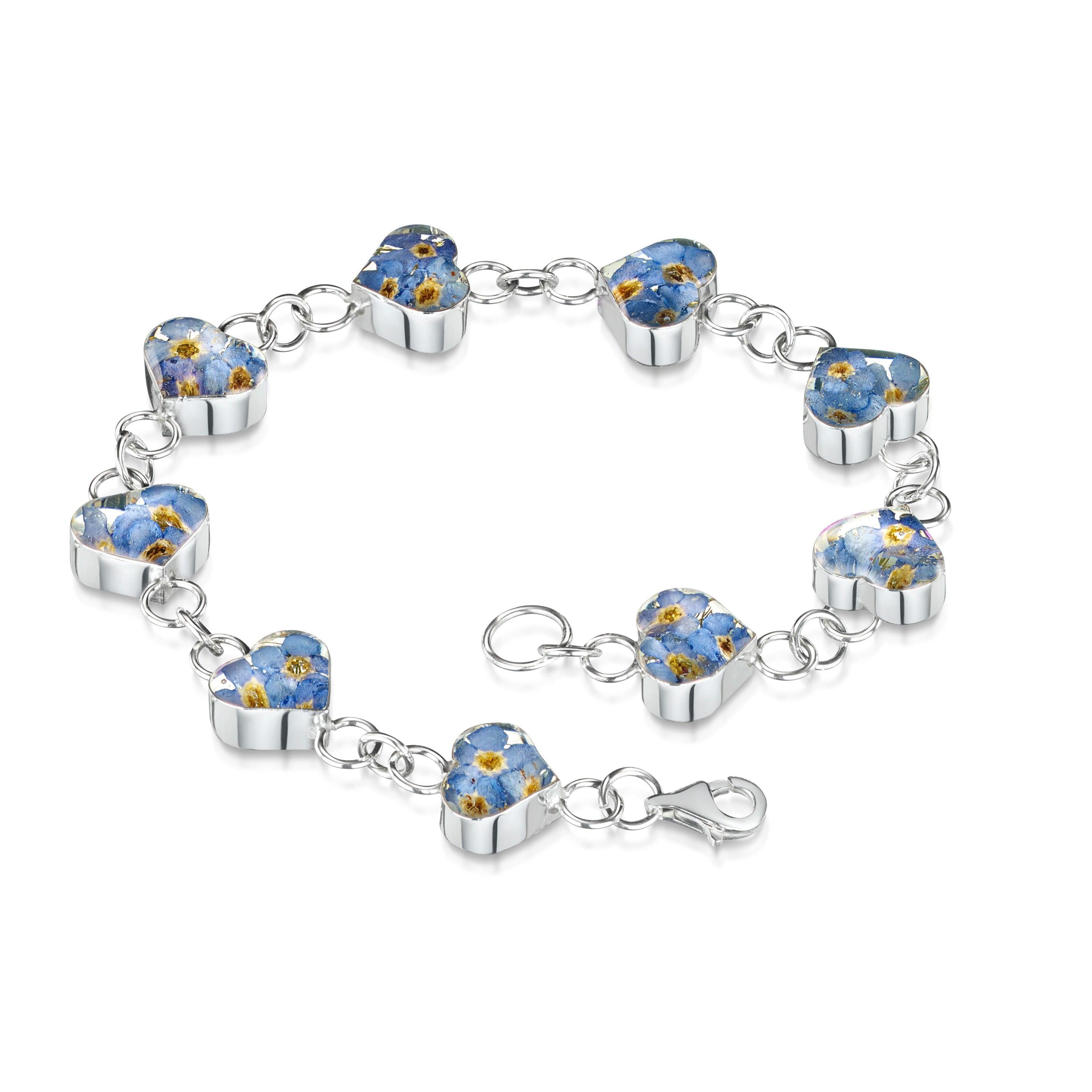 Forget-Me-Not Heart Bracelet in sterling silver and gold-plated options, featuring intricate floral designs and a heart motif.