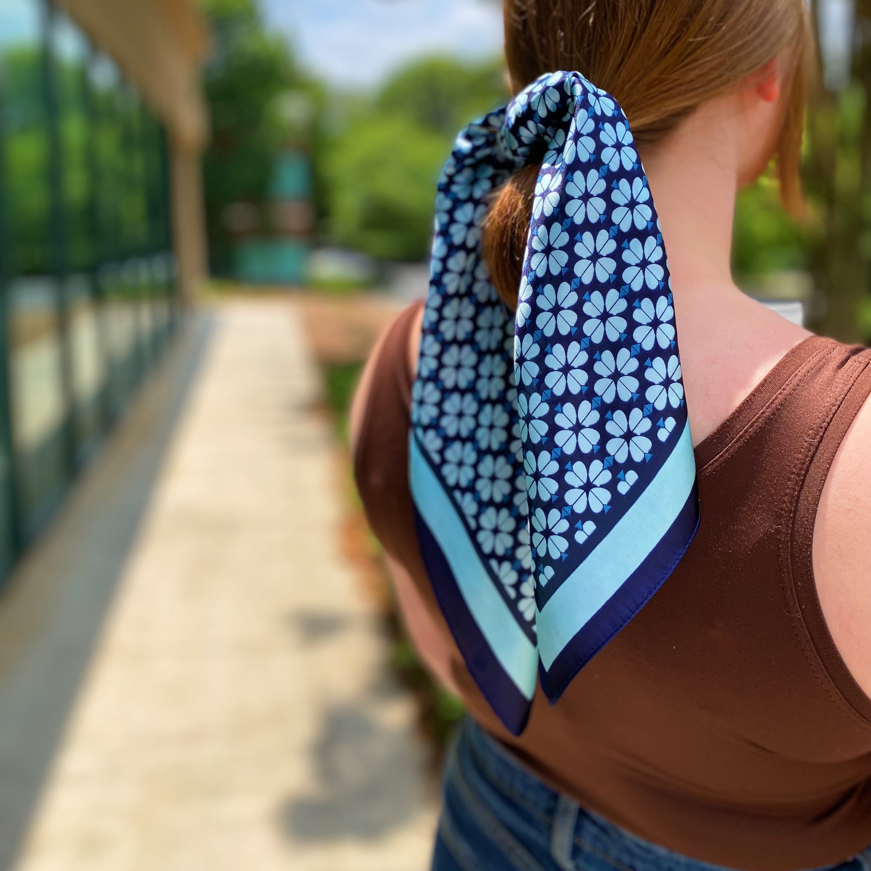 Four Petal Clover Scarf featuring a geometrical clover pattern with a coordinating colored edge, perfect for versatile styling.