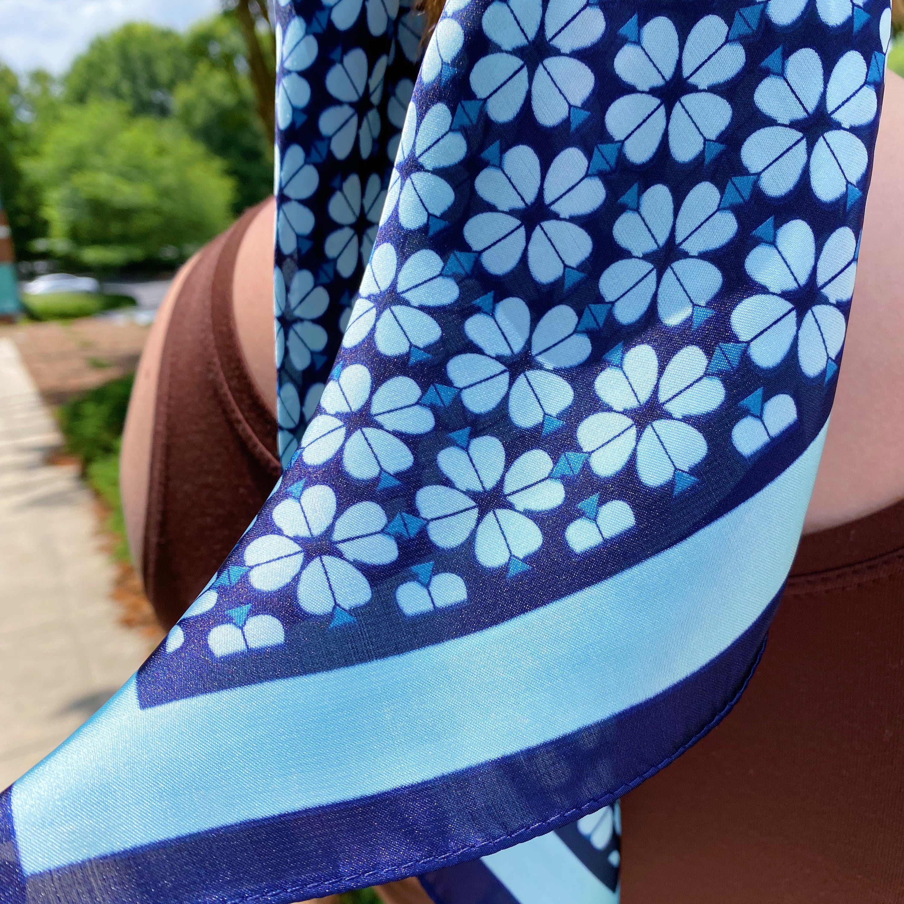 Four Petal Clover Scarf featuring a geometrical clover pattern with a coordinating colored edge, perfect for versatile styling.