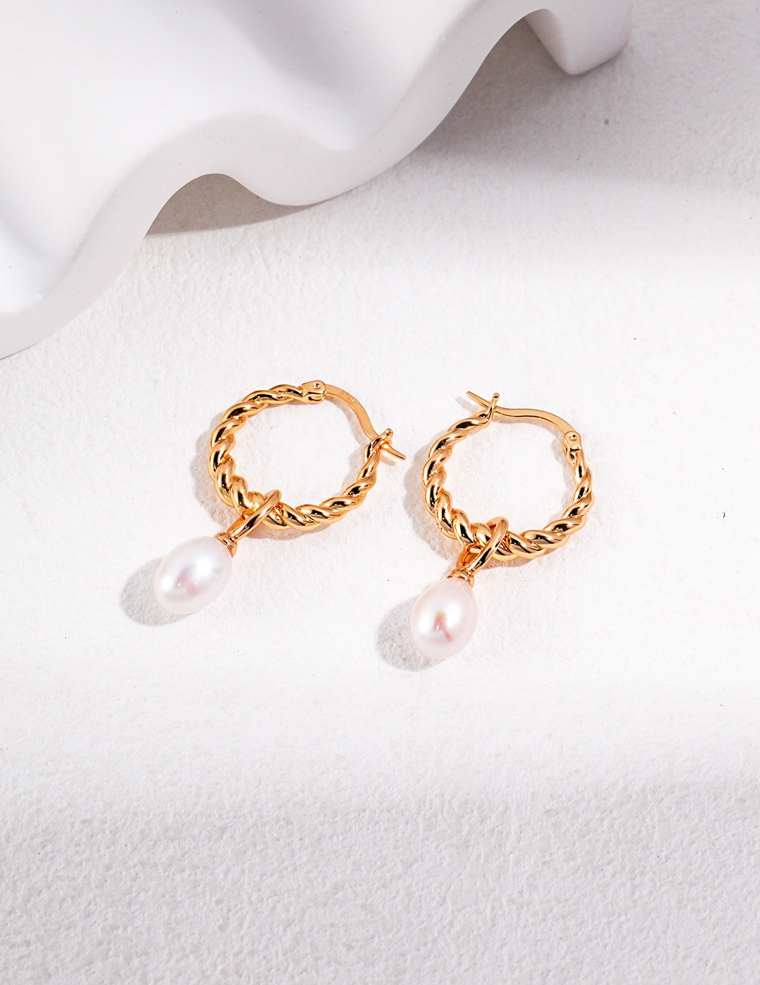 Elegant French Twisted Pearl Hoop Earrings featuring natural pearls and gold vermeil, showcasing a unique twisted design.