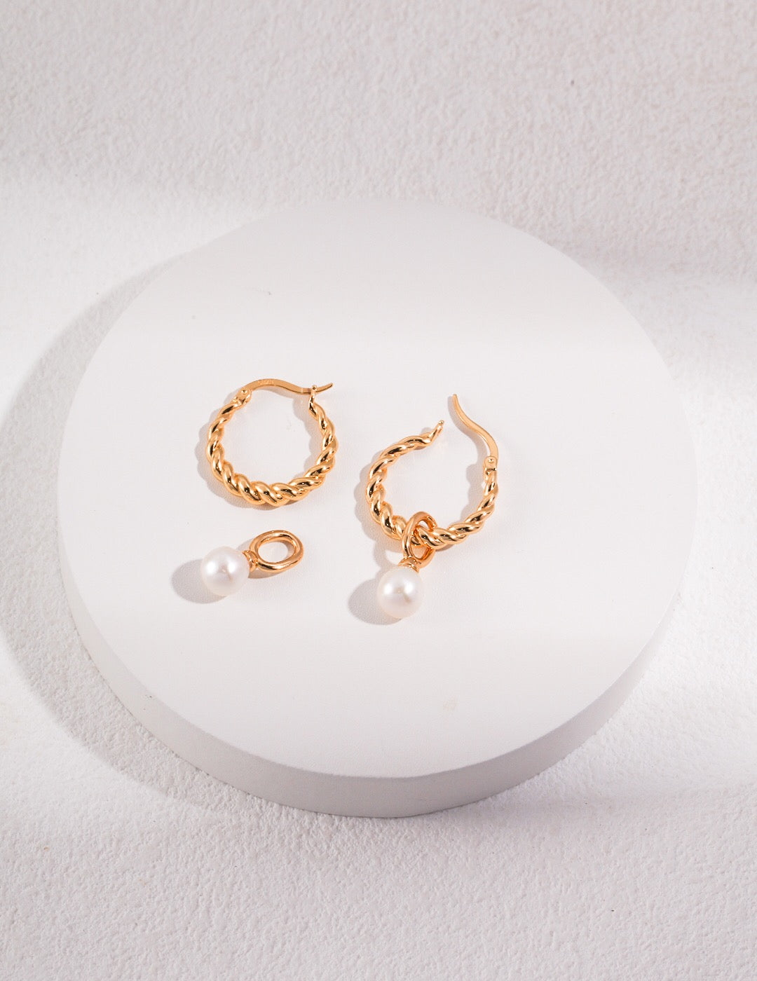 Elegant French Twisted Pearl Hoop Earrings featuring natural pearls and gold vermeil, showcasing a unique twisted design.