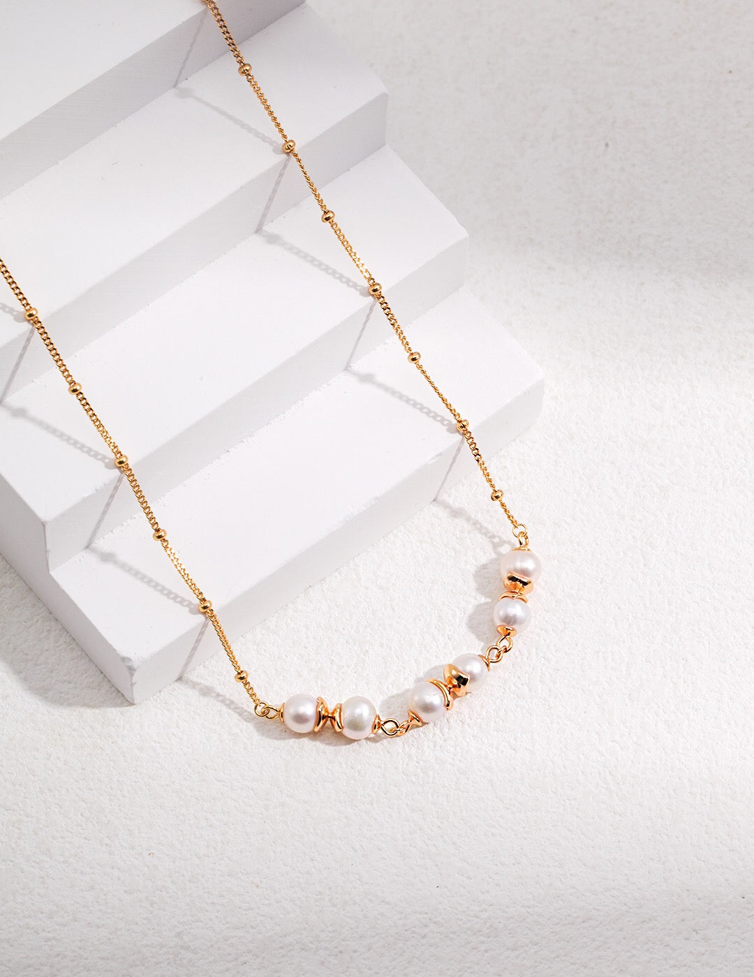 A beautifully handcrafted Freshwater Pearl Beads Spacer Necklace featuring natural pearls and gold vermeil accents, elegantly displayed on a soft background.