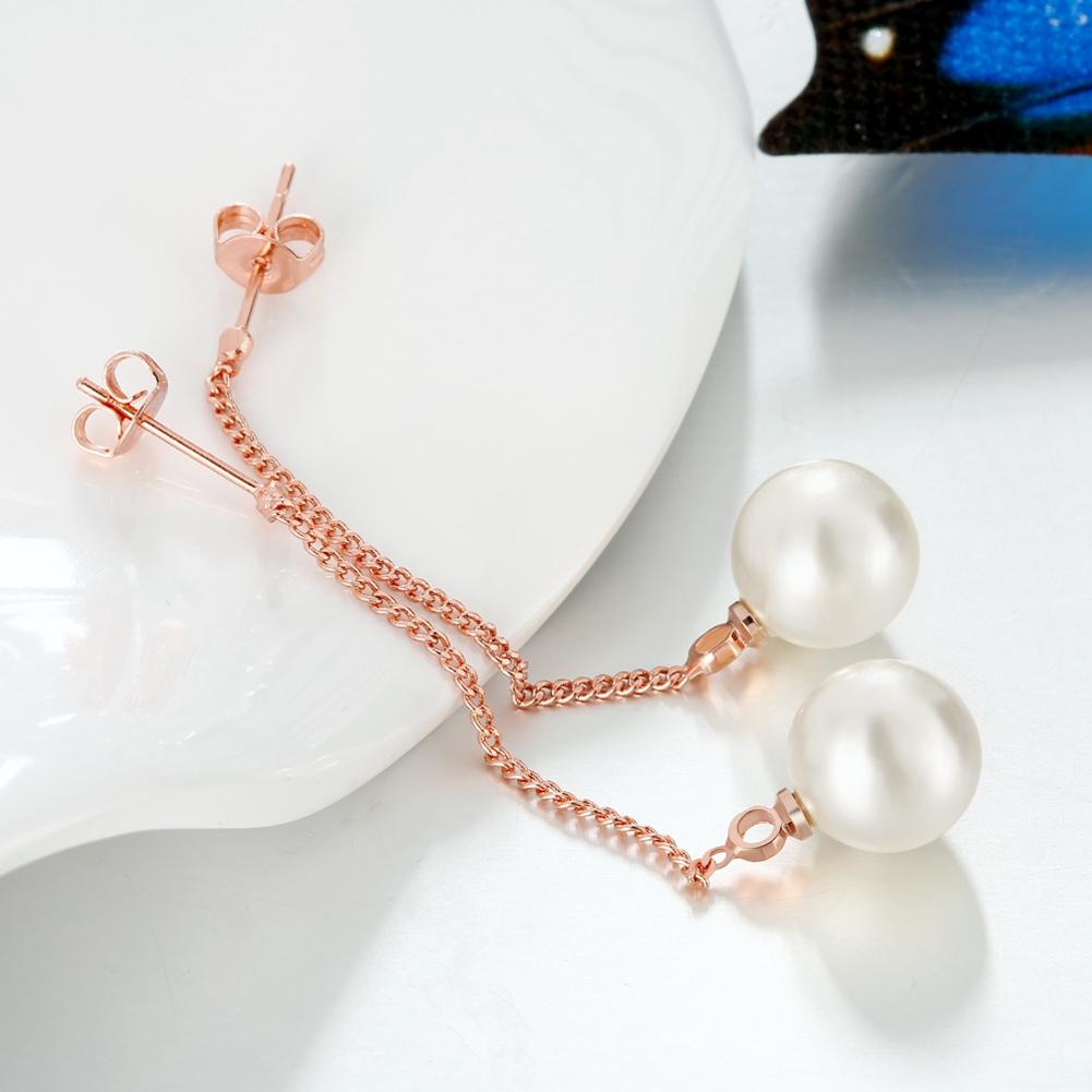 Elegant freshwater pearl dangling link earrings in 18K rose gold plating, showcasing a modern design.