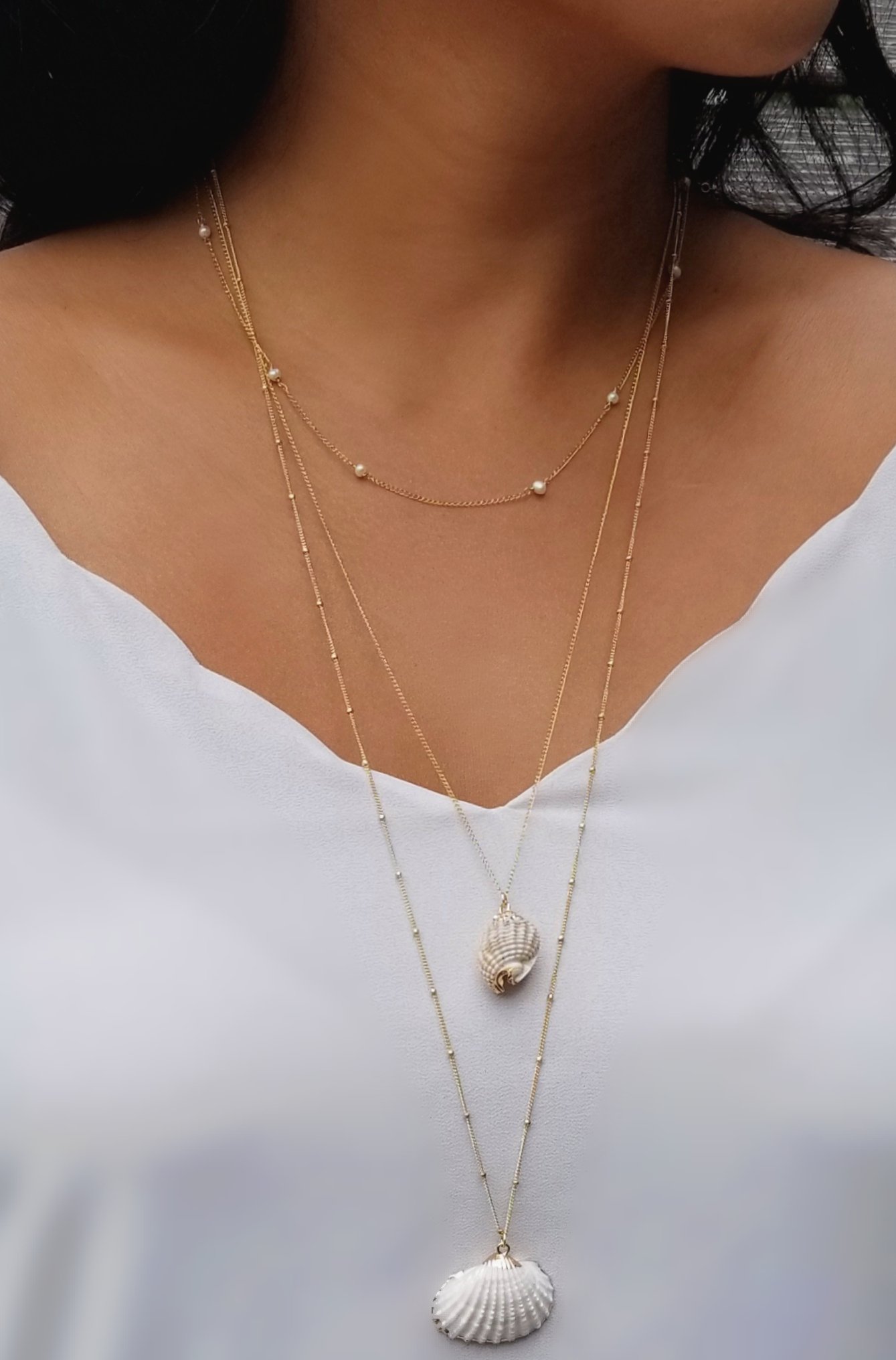 A delicate strand of tiny Freshwater Pearls on a 14KT Gold-filled chain, showcasing its versatility as an anklet, bracelet, or necklace.