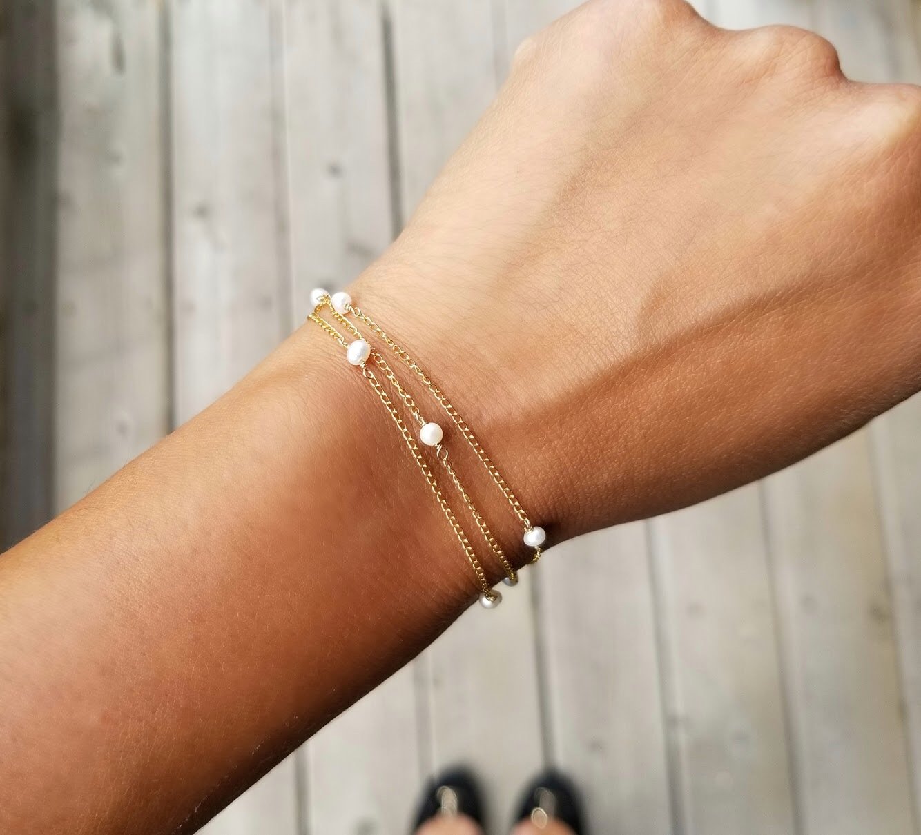 A delicate strand of tiny Freshwater Pearls on a 14KT Gold-filled chain, showcasing its versatility as an anklet, bracelet, or necklace.