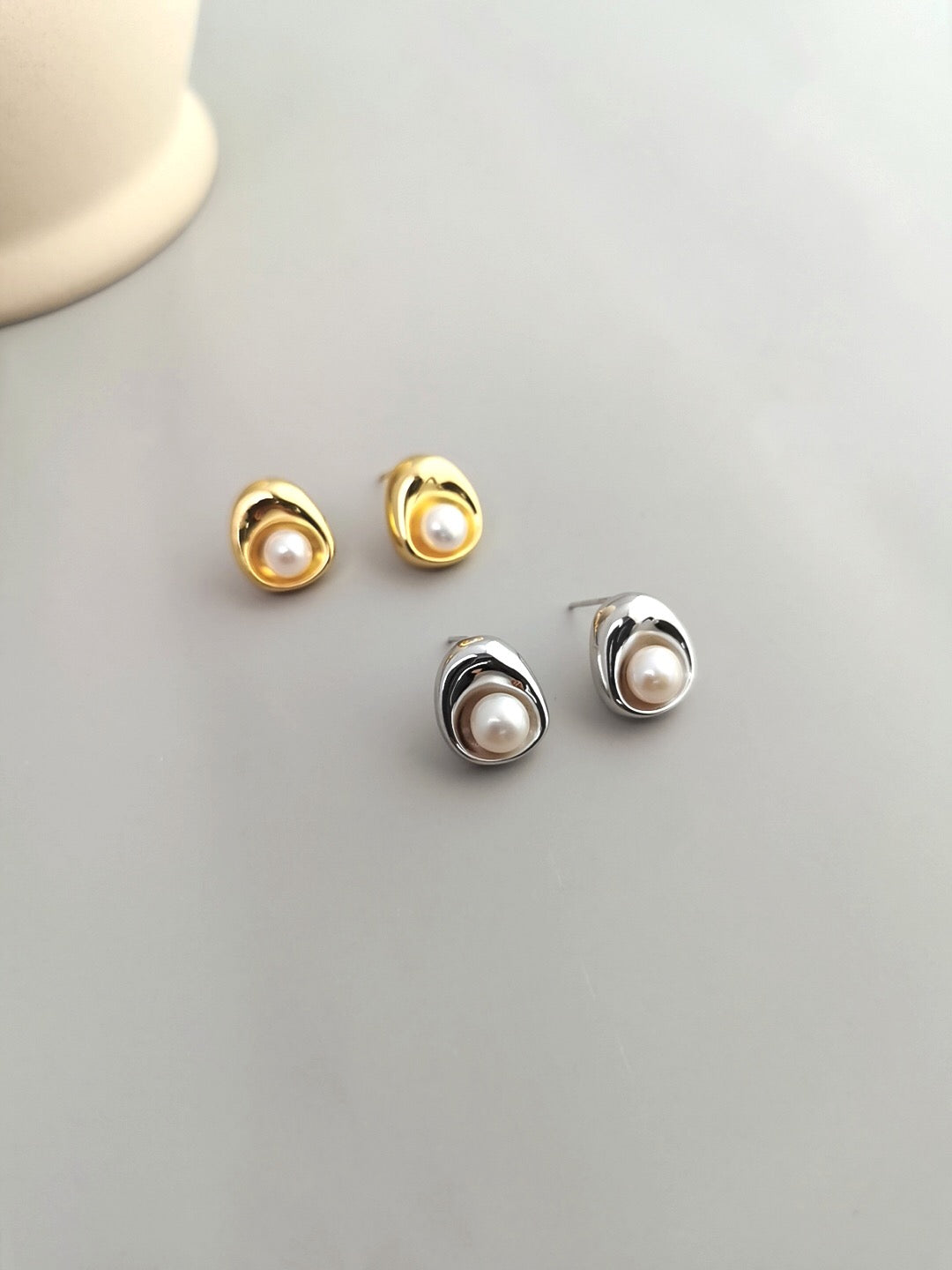 A pair of elegant Freshwater Pearl Stud Earrings featuring natural pearls set in sterling silver with gold vermeil plating.