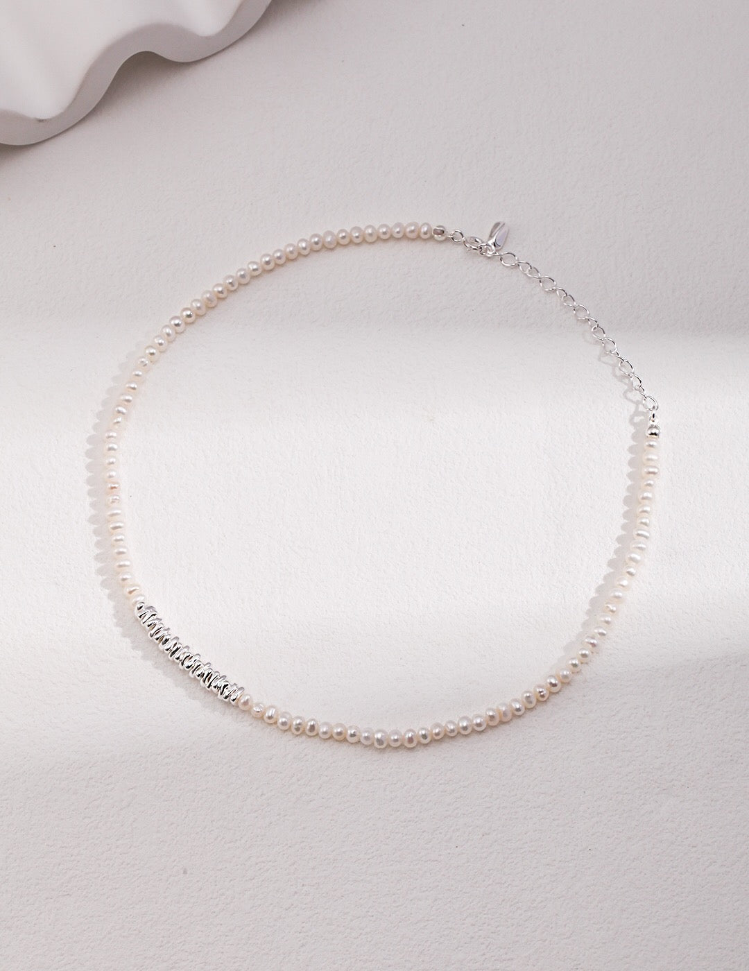 A beautiful Freshwater Pearl Necklace featuring gold vermeil and sterling silver beads, elegantly displayed on a soft fabric background.