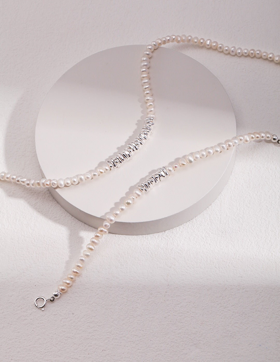 A beautiful Freshwater Pearl Necklace featuring gold vermeil and sterling silver beads, elegantly displayed on a soft fabric background.