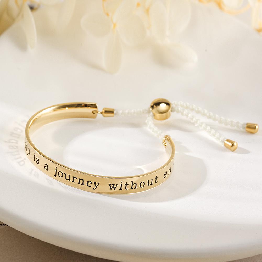 A stylish FRIENDSHIP BANGLE CUFF bracelet with an engraved charm reading 'A true friendship is a journey without an end', perfect for gifting.