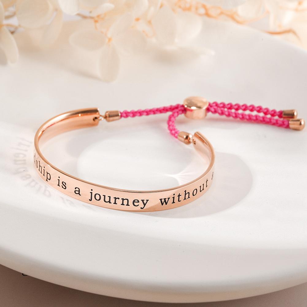 A stylish FRIENDSHIP BANGLE CUFF bracelet with an engraved charm reading 'A true friendship is a journey without an end', perfect for gifting.