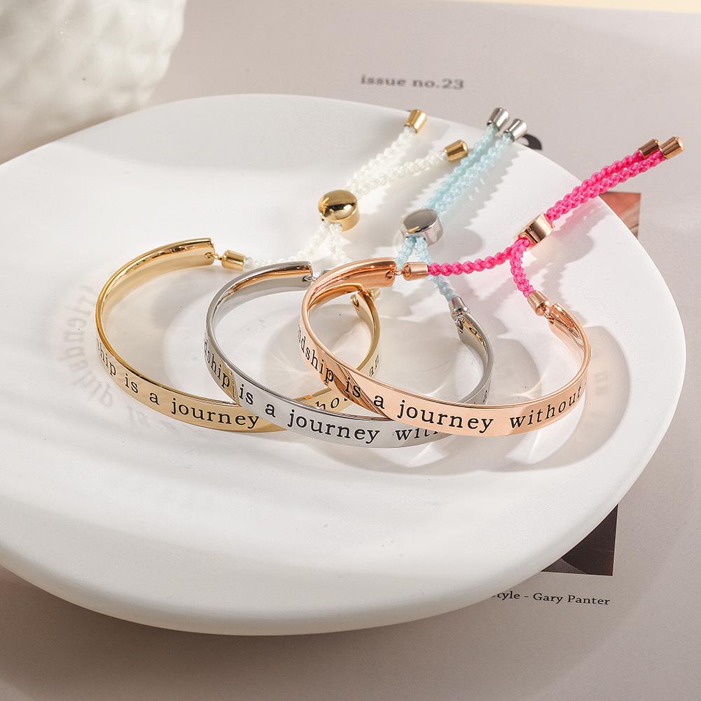 A stylish FRIENDSHIP BANGLE CUFF bracelet with an engraved charm reading 'A true friendship is a journey without an end', perfect for gifting.