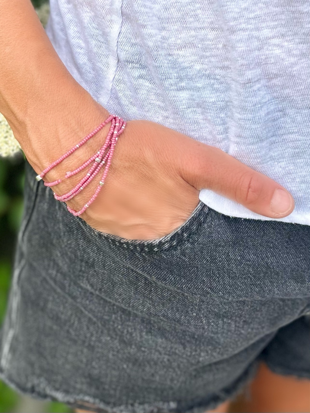 Fuchsia beaded 5-wrap bracelet with silver sprinkles on elastic cording, showcasing vibrant colors and intricate design.