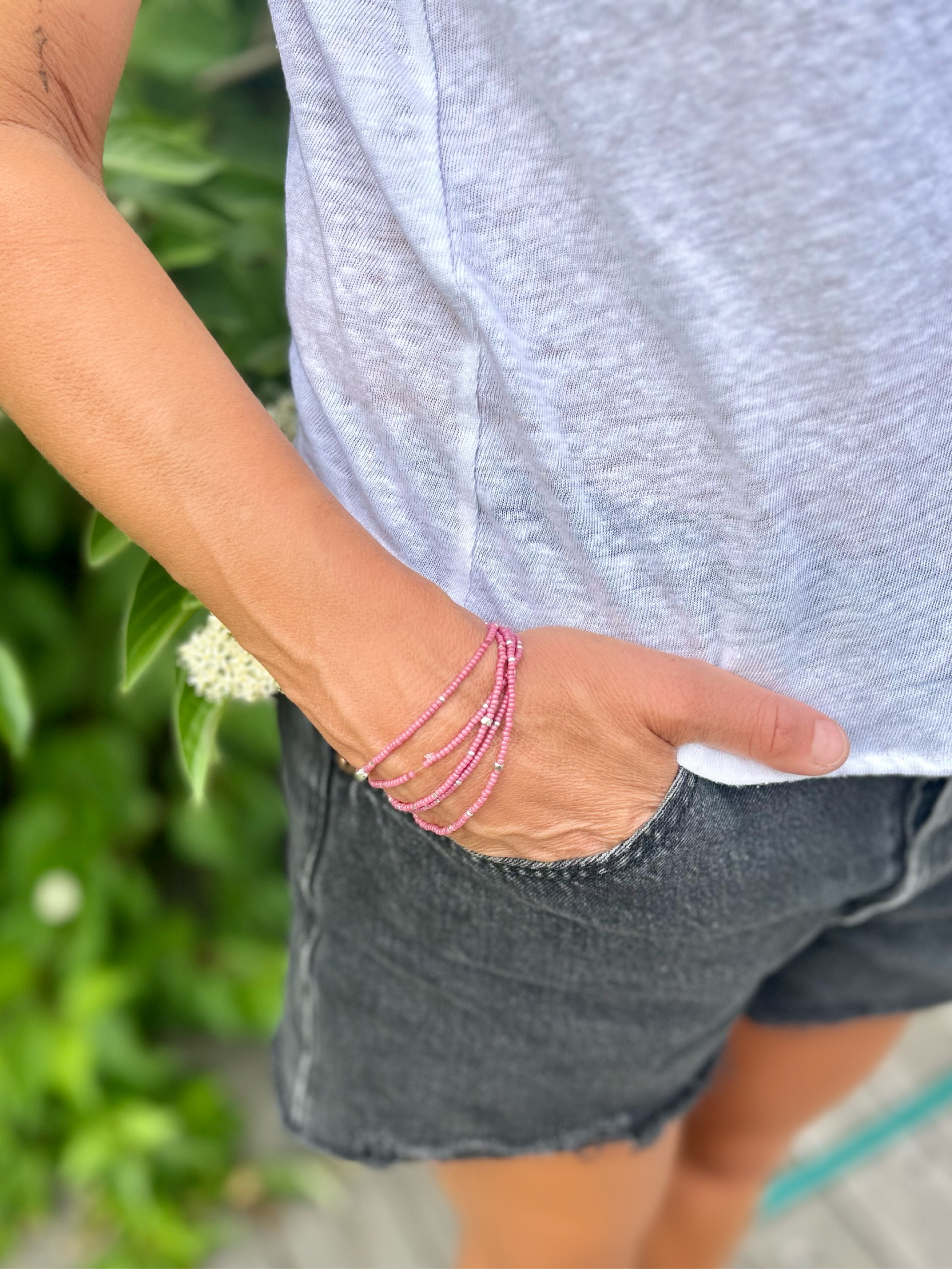 Fuchsia beaded 5-wrap bracelet with silver sprinkles on elastic cording, showcasing vibrant colors and intricate design.