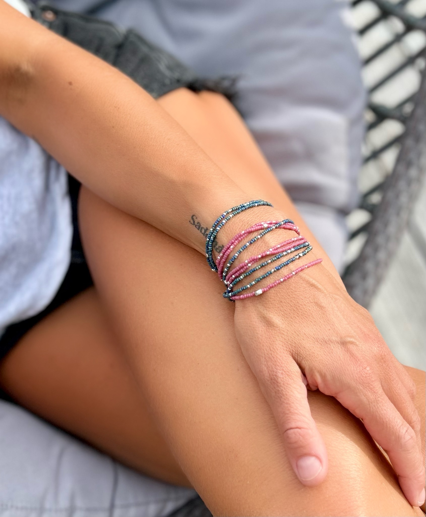 Fuchsia beaded 5-wrap bracelet with silver sprinkles on elastic cording, showcasing vibrant colors and intricate design.