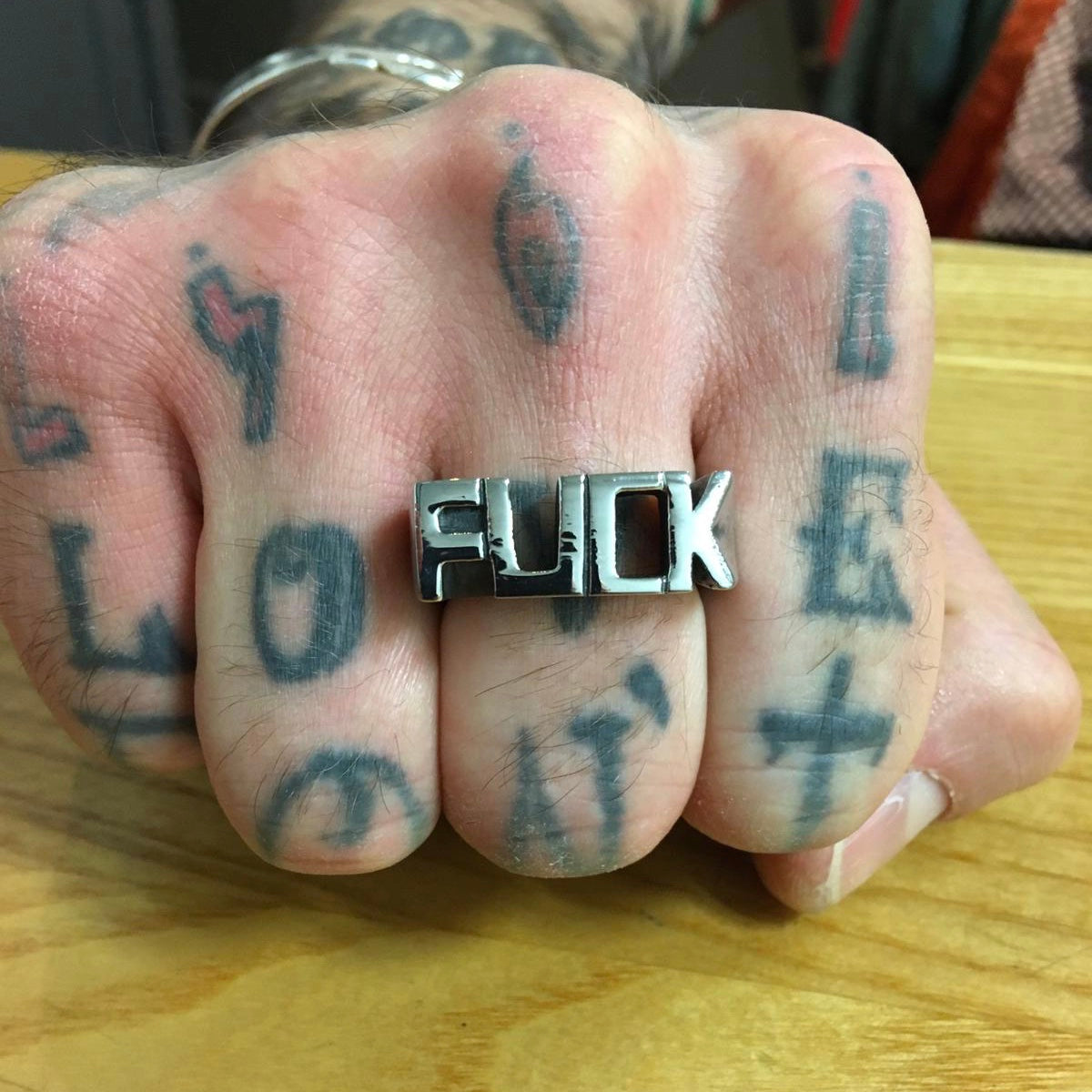 FUCK Stainless Steel Ring showcasing its bold design and shiny finish, available in various sizes and colors.