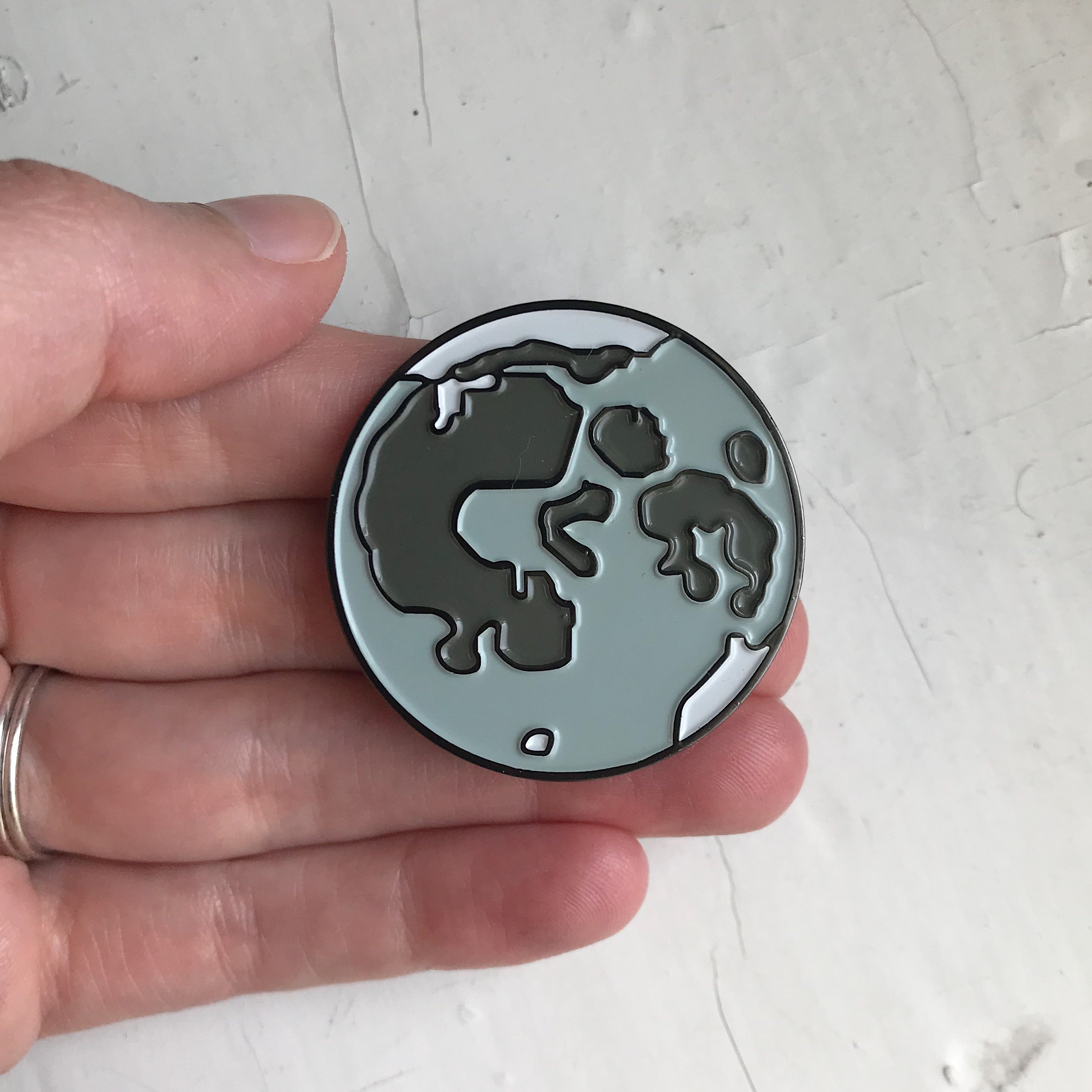 Full Moon Enamel Pin featuring a detailed illustration of the moon, perfect for jackets and backpacks.