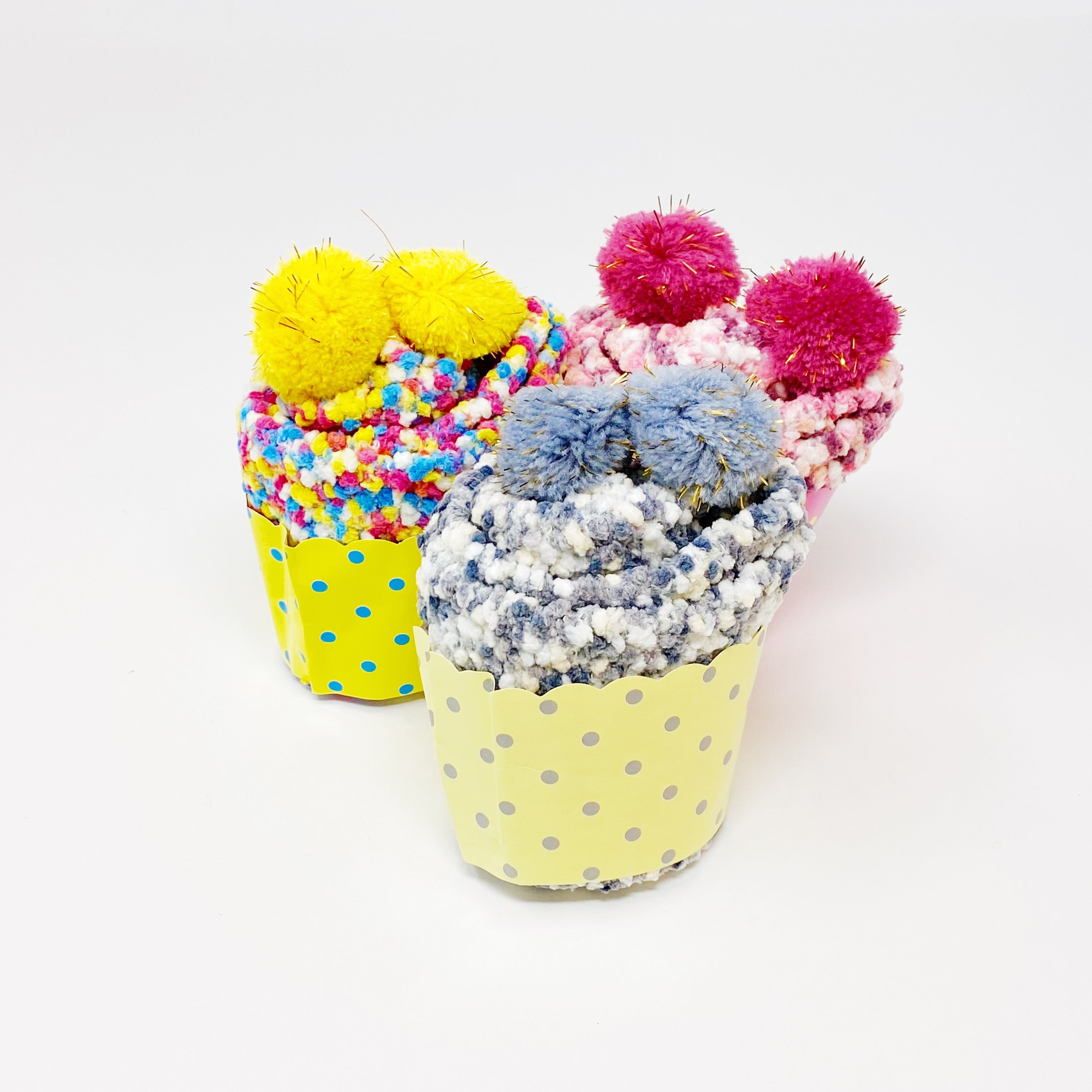 Soft and fuzzy Fuzzy Pom Confetti Socks with a cute pom detail on the back, displayed in cupcake packaging.