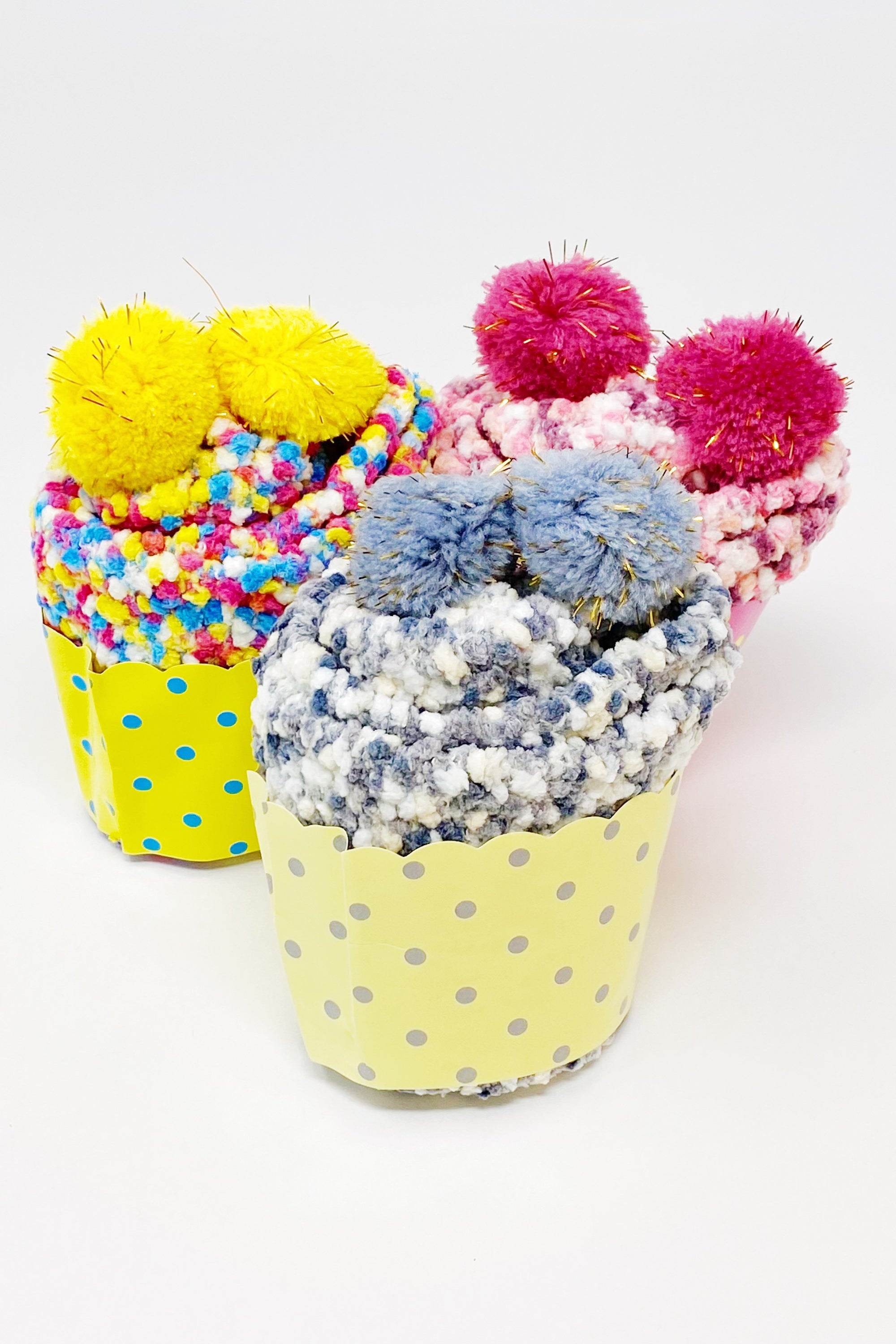 Soft and fuzzy Fuzzy Pom Confetti Socks with a cute pom detail on the back, displayed in cupcake packaging.