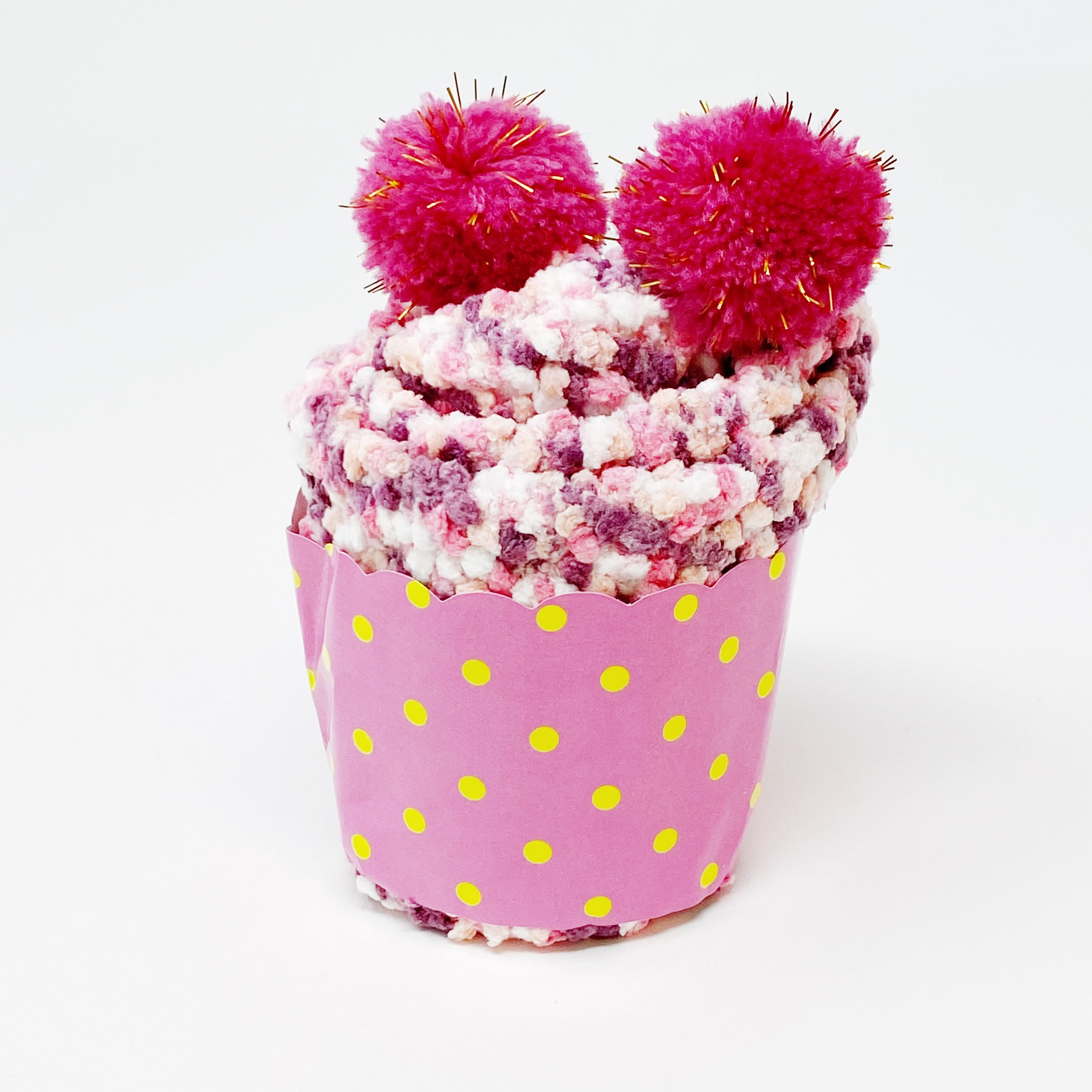 Soft and fuzzy Fuzzy Pom Confetti Socks with a cute pom detail on the back, displayed in cupcake packaging.