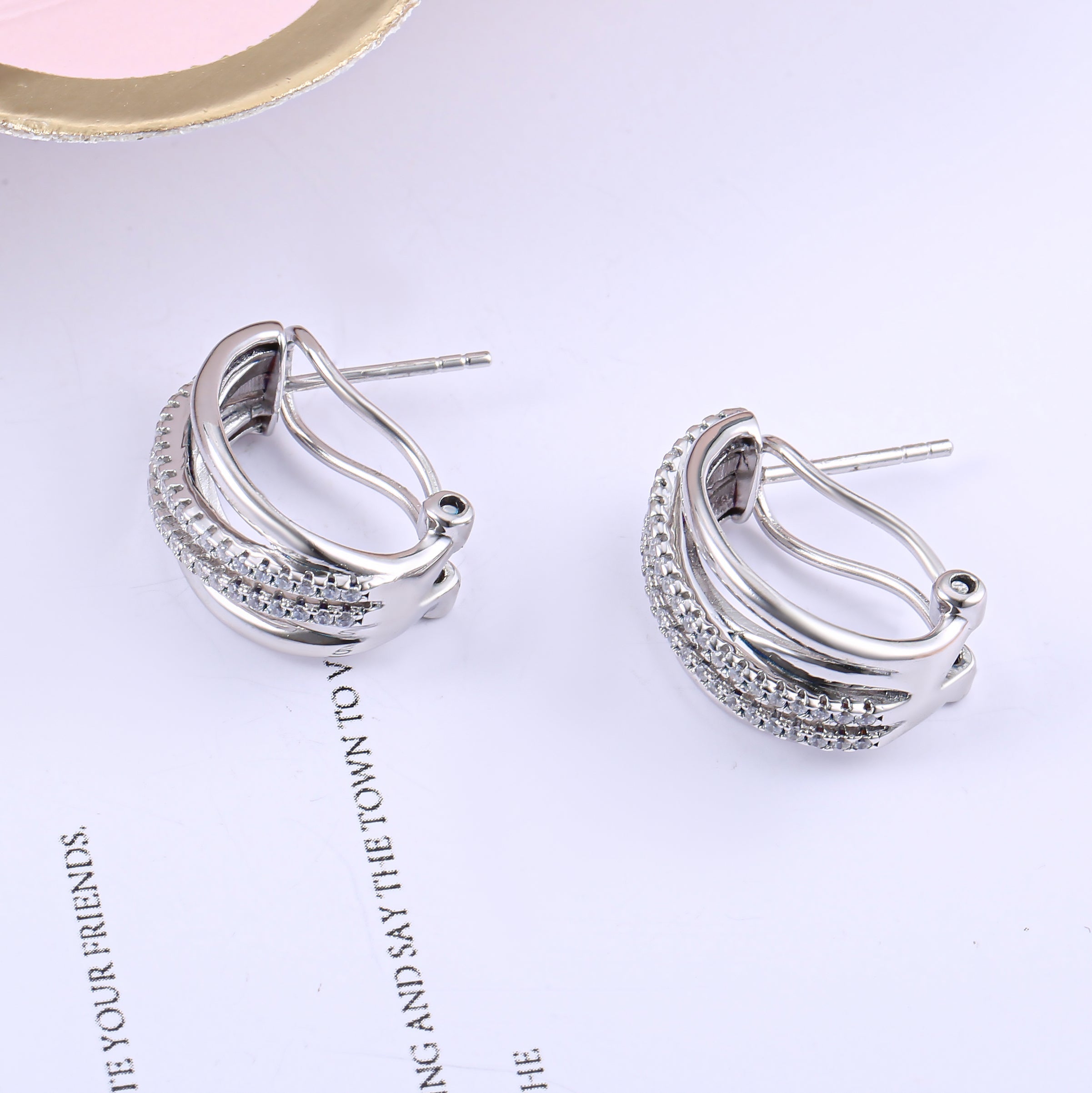 Galaxy Omega stud earrings made of 925 sterling silver with white sapphire, showcasing a luxurious design.