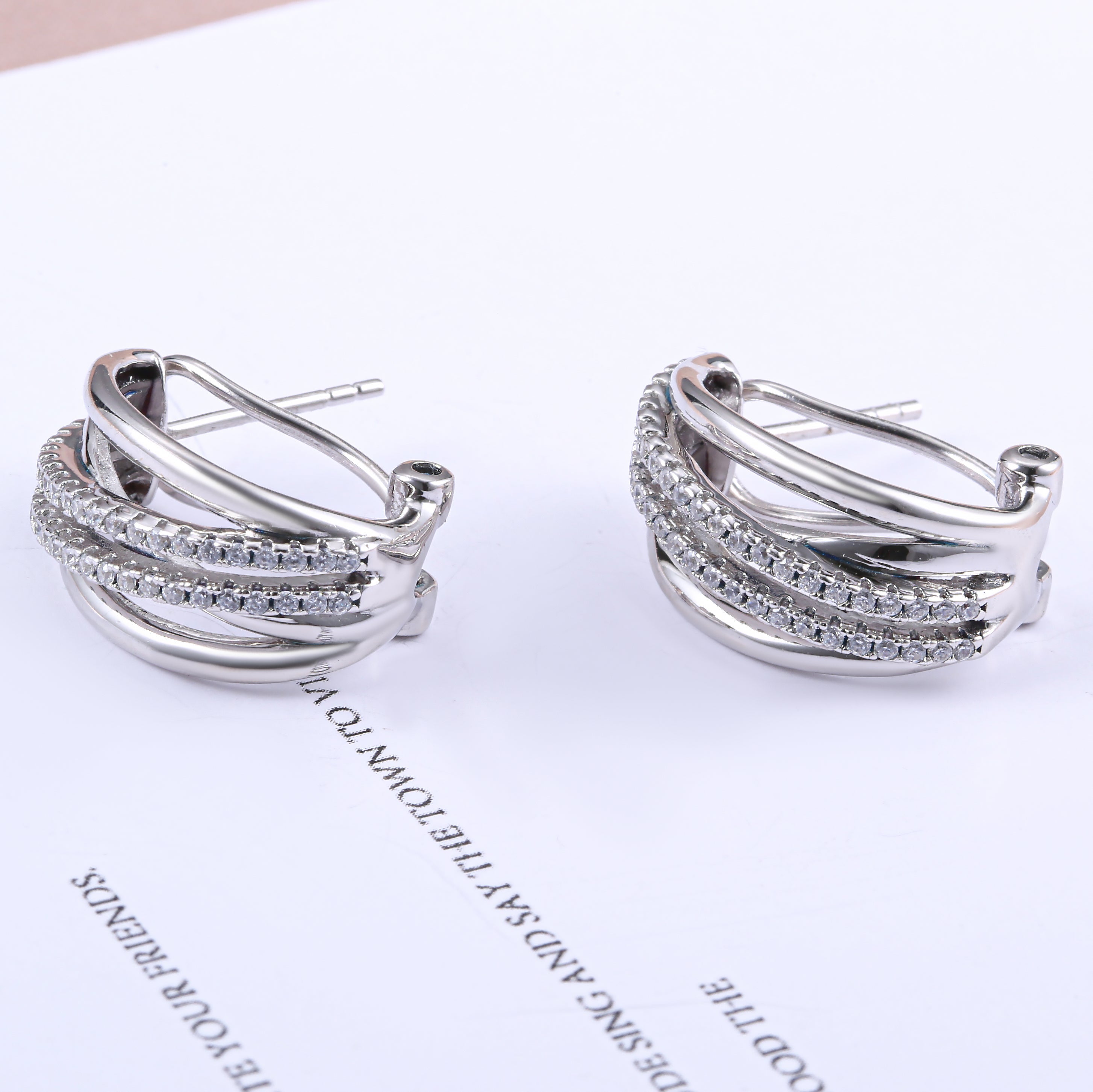 Galaxy Omega stud earrings made of 925 sterling silver with white sapphire, showcasing a luxurious design.