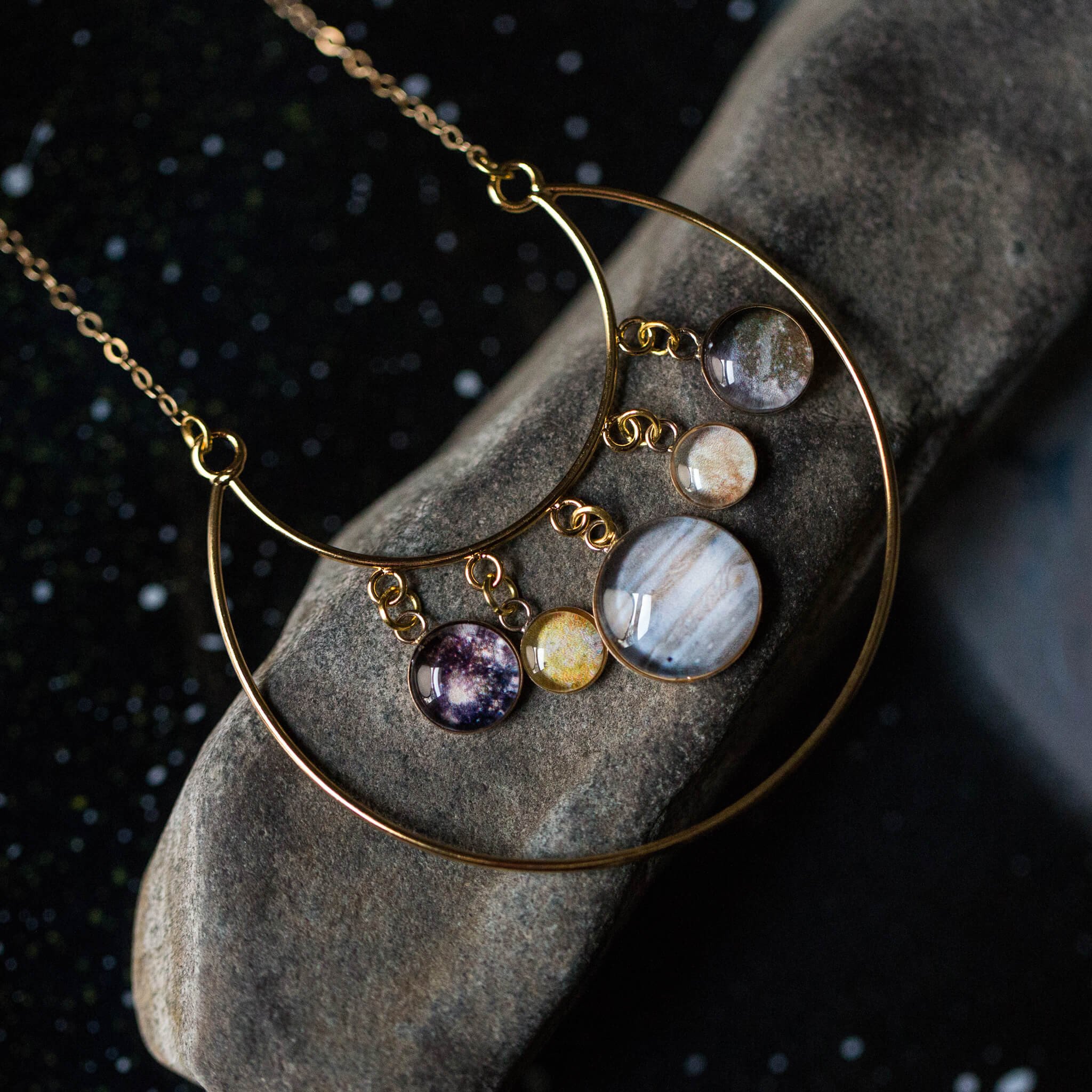 Galilean Moons of Jupiter Statement Necklace featuring Jupiter and its four largest moons in a stunning gold design.