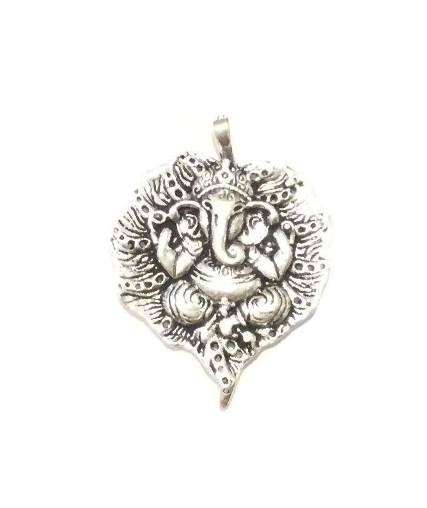 Intricate handmade Ganesha pendant engraved on a leaf, showcasing detailed craftsmanship in brass and silver plating.