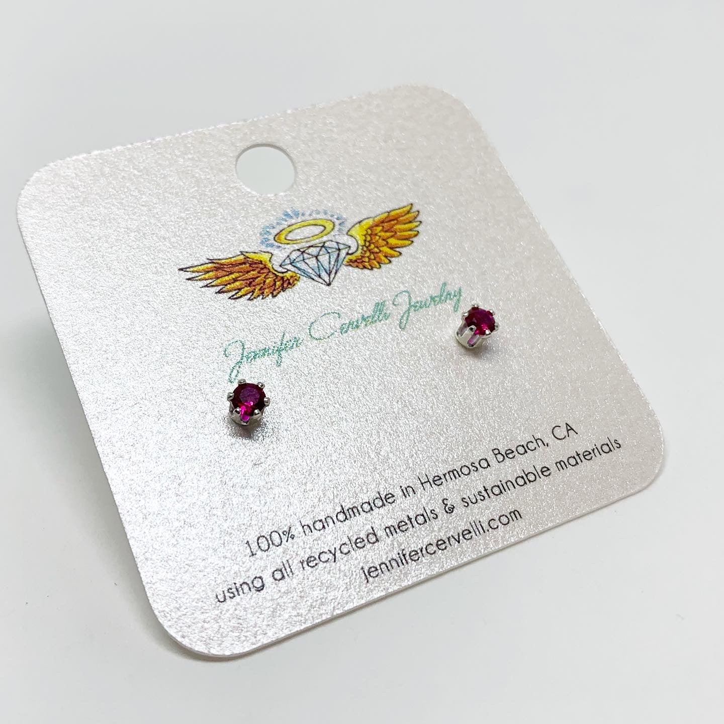 A pair of stunning garnet birthstone earrings featuring 3mm round faceted pink-red garnet gemstones set in sterling silver or yellow gold fill.