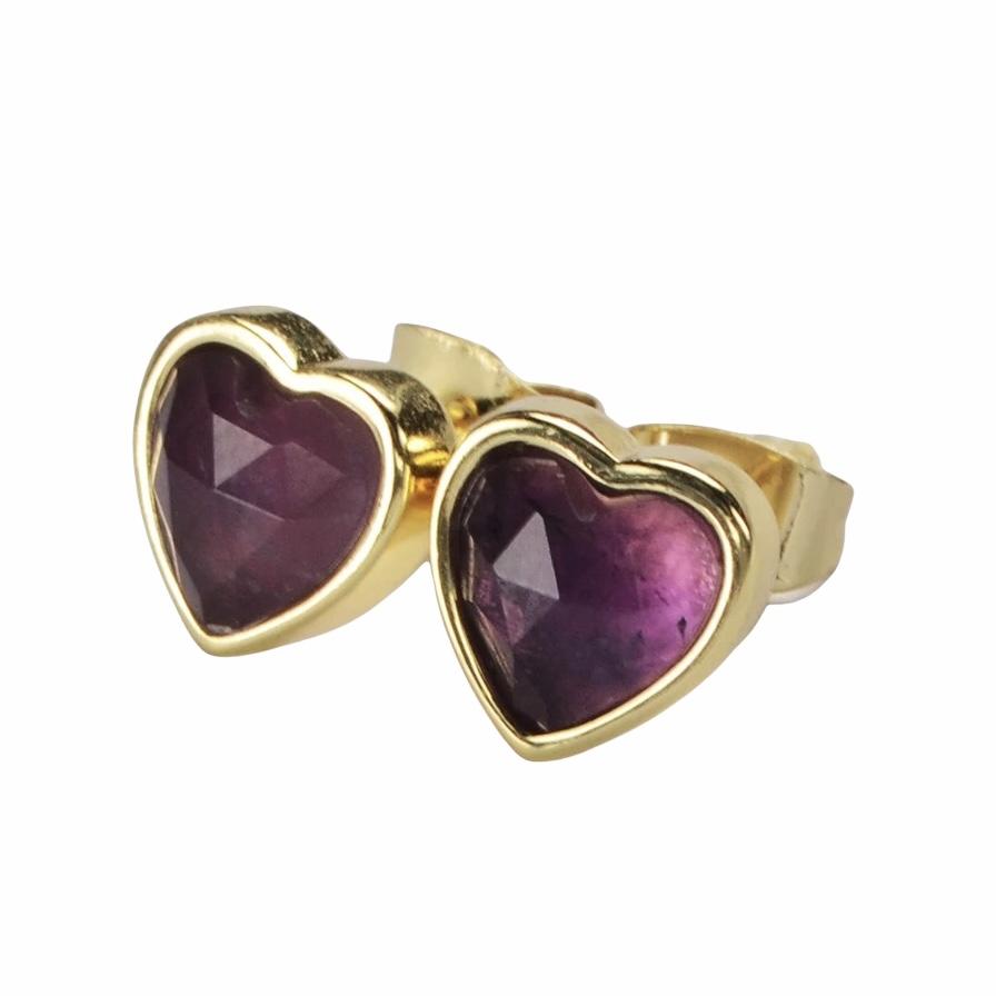 A pair of heart-shaped gemstone studs in amethyst, moonstone, and rose quartz, set in brass with 18K gold plating.