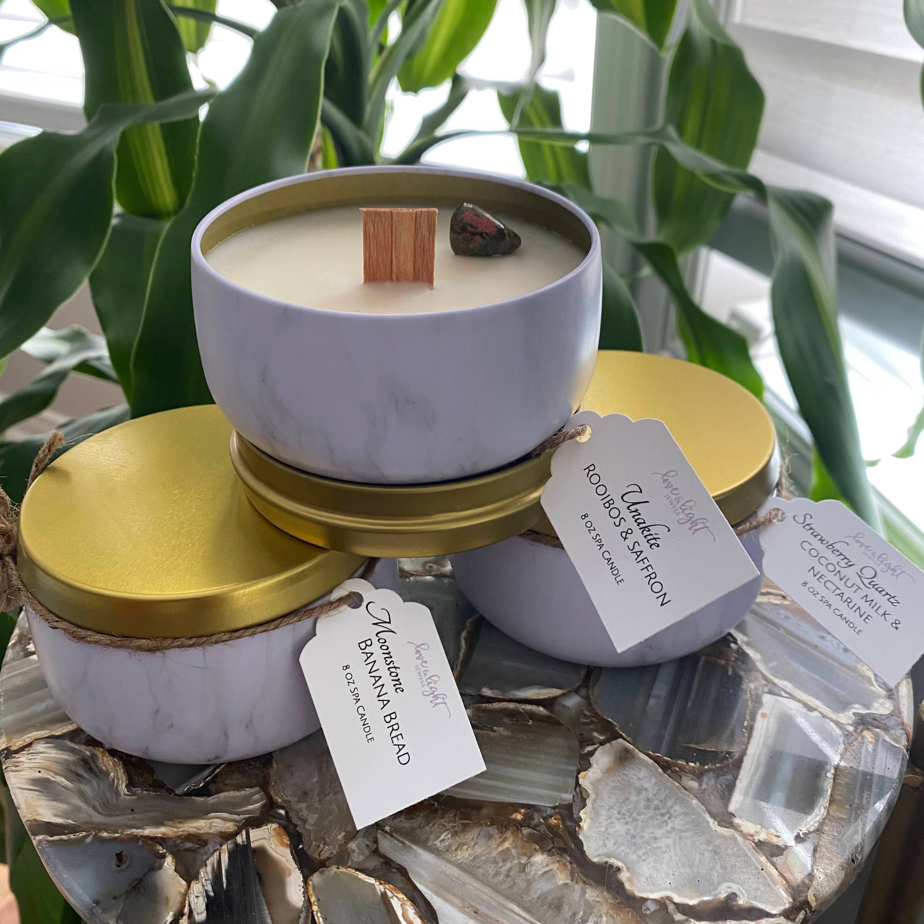 Gemstone Spa Candle in a travel tin with a wooden wick and a tumbled stone accent, showcasing its unique design and soothing ambiance.