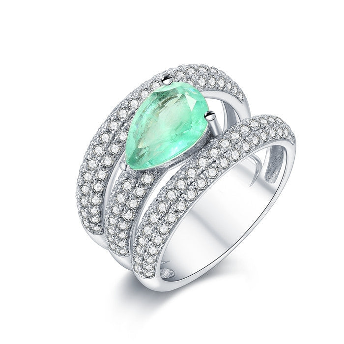 A stunning gemstone ring featuring a blue paraiba stone set in 925 sterling silver with a white gold finish, showcasing elegance and craftsmanship.