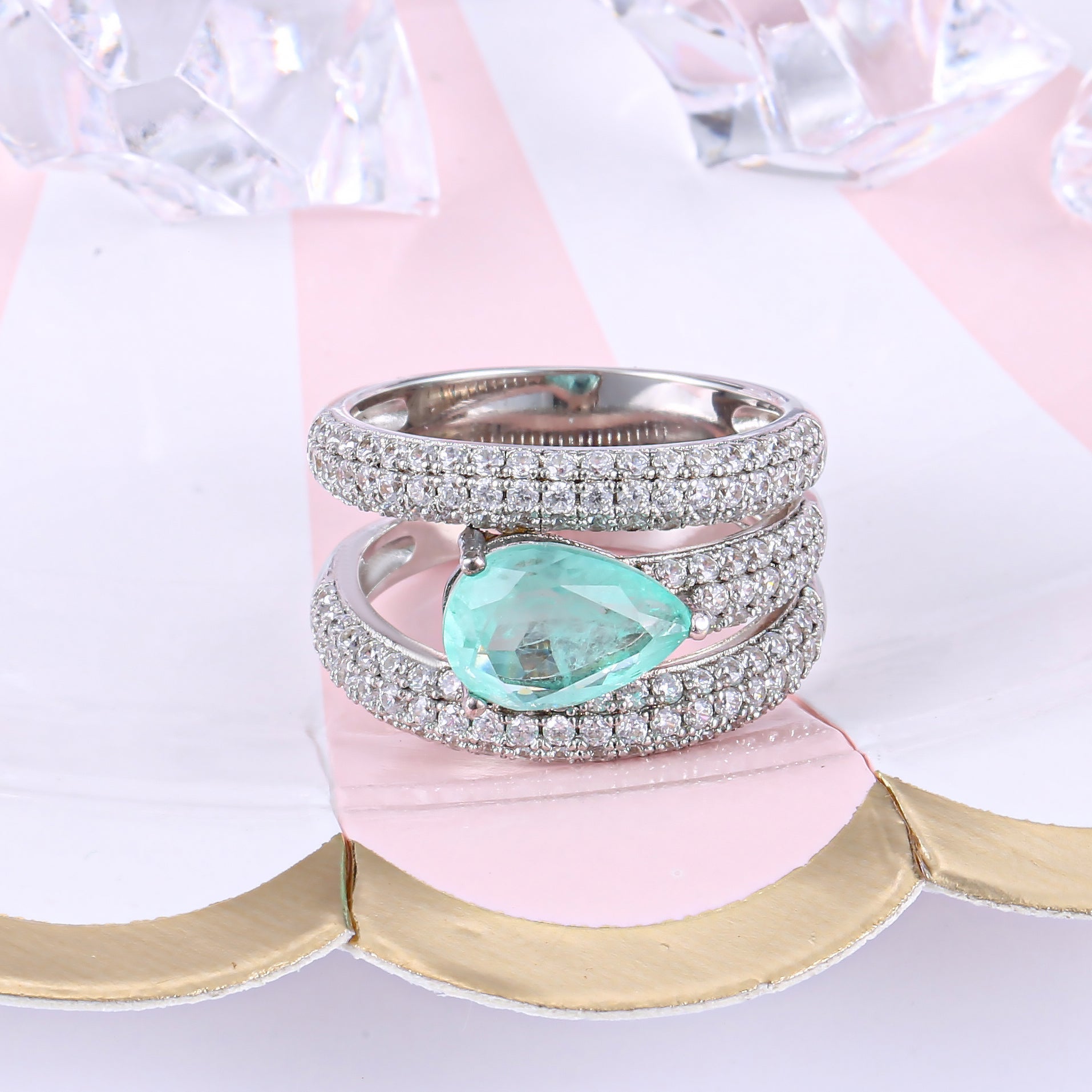 A stunning gemstone ring featuring a blue paraiba stone set in 925 sterling silver with a white gold finish, showcasing elegance and craftsmanship.