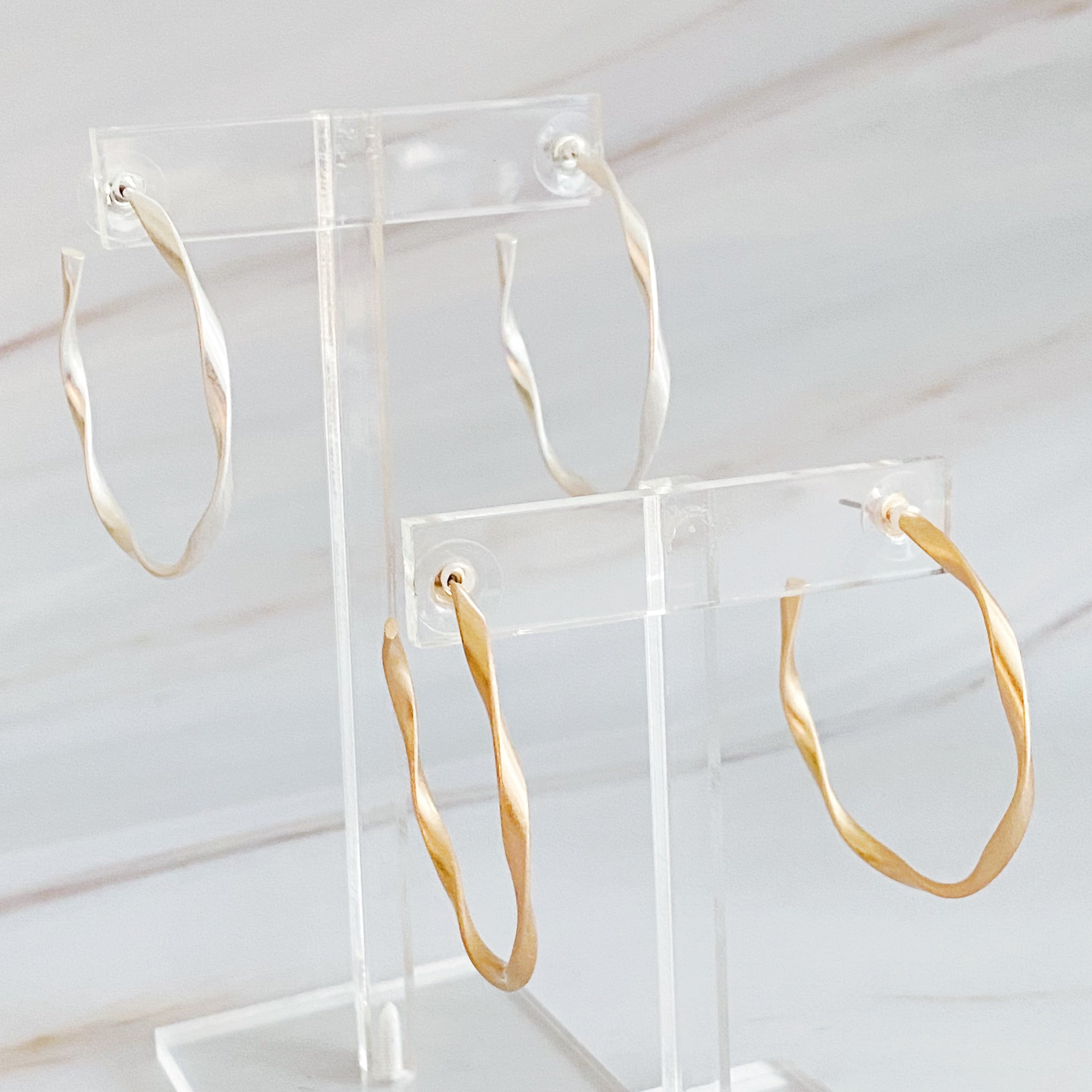 Gentle Wave Sleek Hoop Earrings with a softly twisted design and matte finish, showcasing their elegant and modern style.