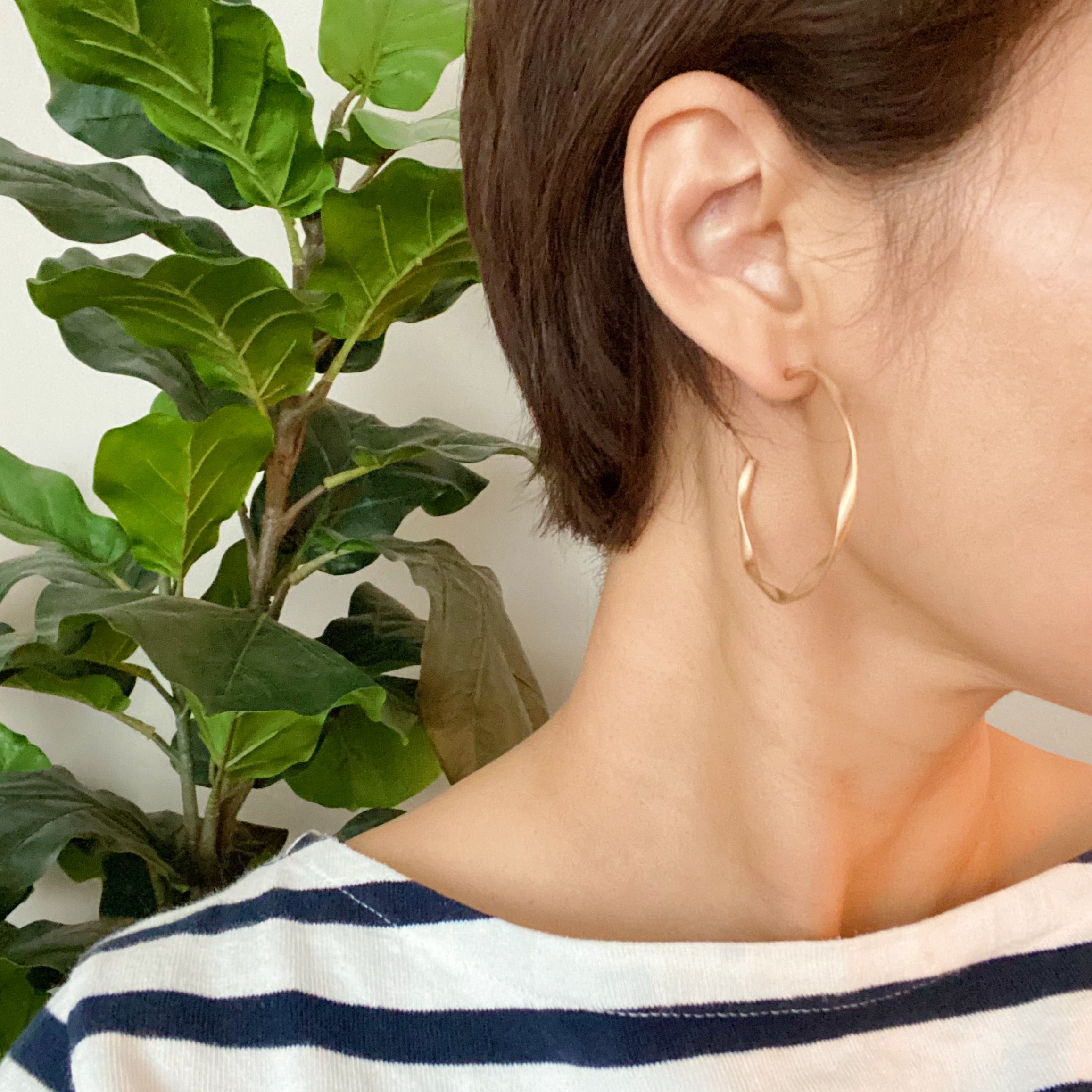 Gentle Wave Sleek Hoop Earrings with a softly twisted design and matte finish, showcasing their elegant and modern style.