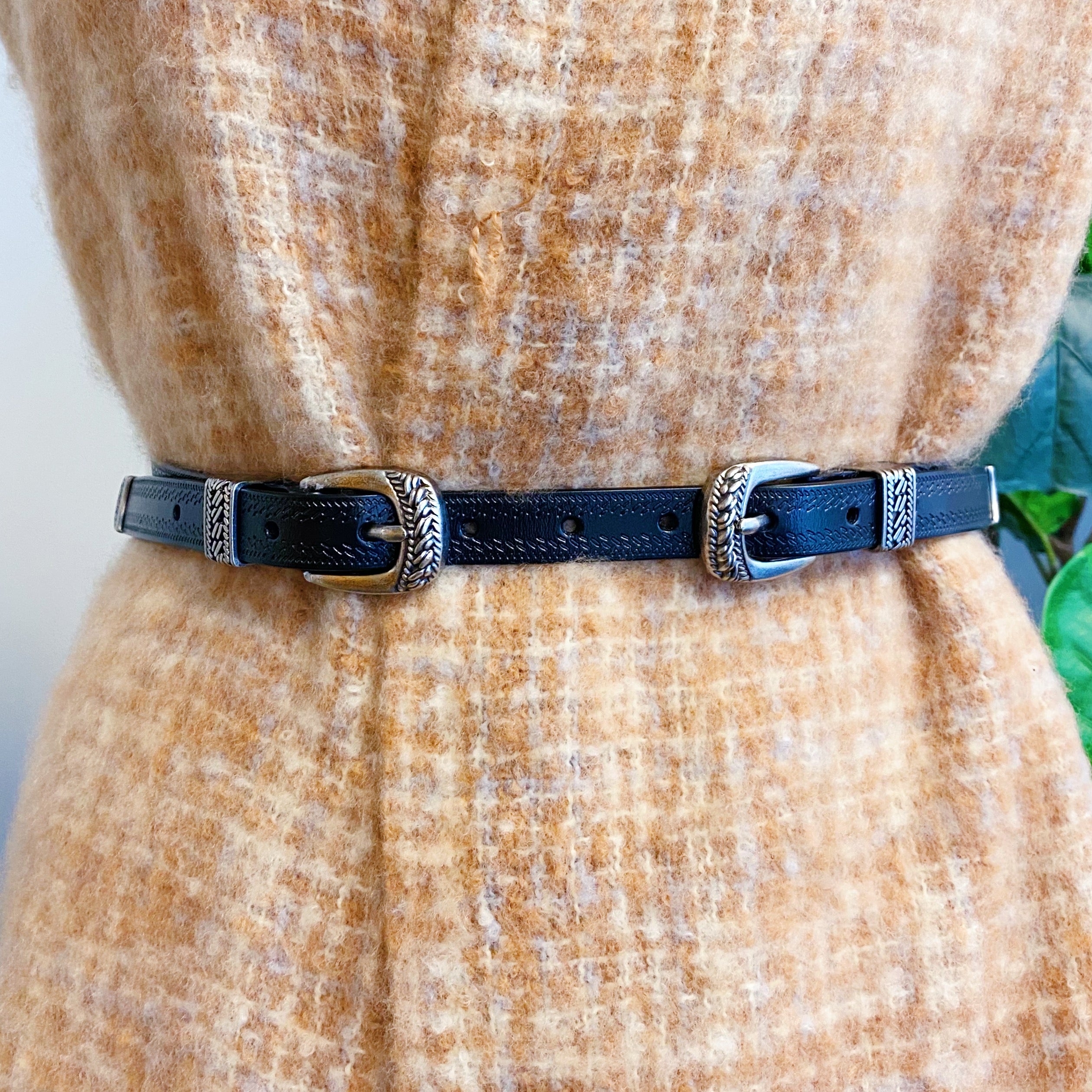 Genuine Double Buckle Belt made of premium leather with detailed patterns and silver-tone hardware, showcasing its stylish design.