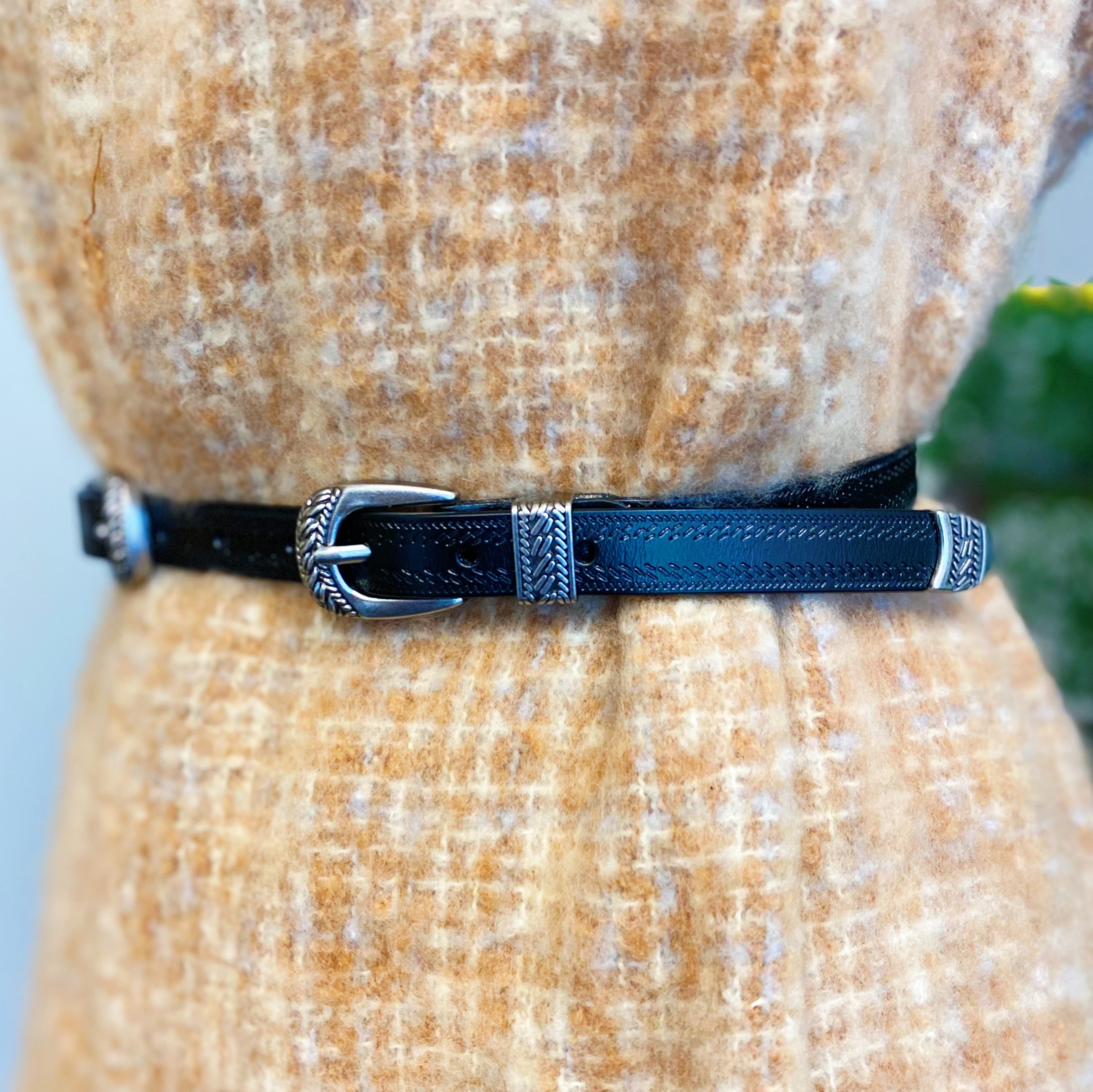 Genuine Double Buckle Belt made of premium leather with detailed patterns and silver-tone hardware, showcasing its stylish design.