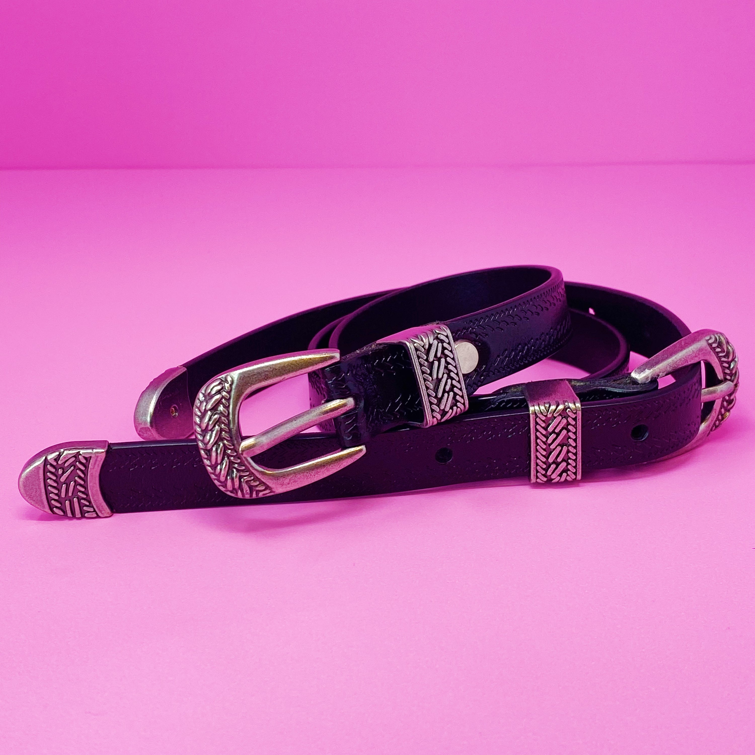 Genuine Double Buckle Belt made of premium leather with detailed patterns and silver-tone hardware, showcasing its stylish design.