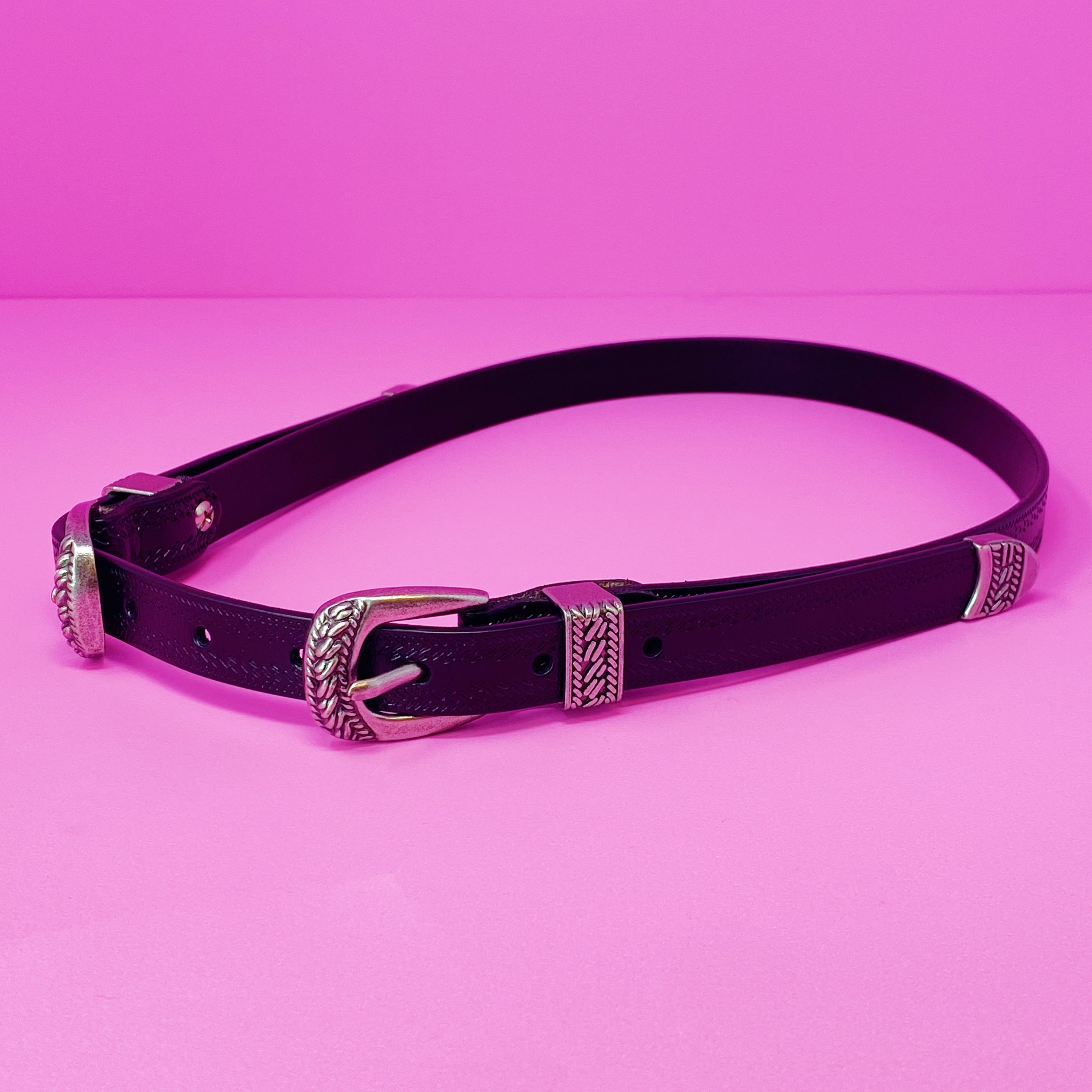 Genuine Double Buckle Belt made of premium leather with detailed patterns and silver-tone hardware, showcasing its stylish design.