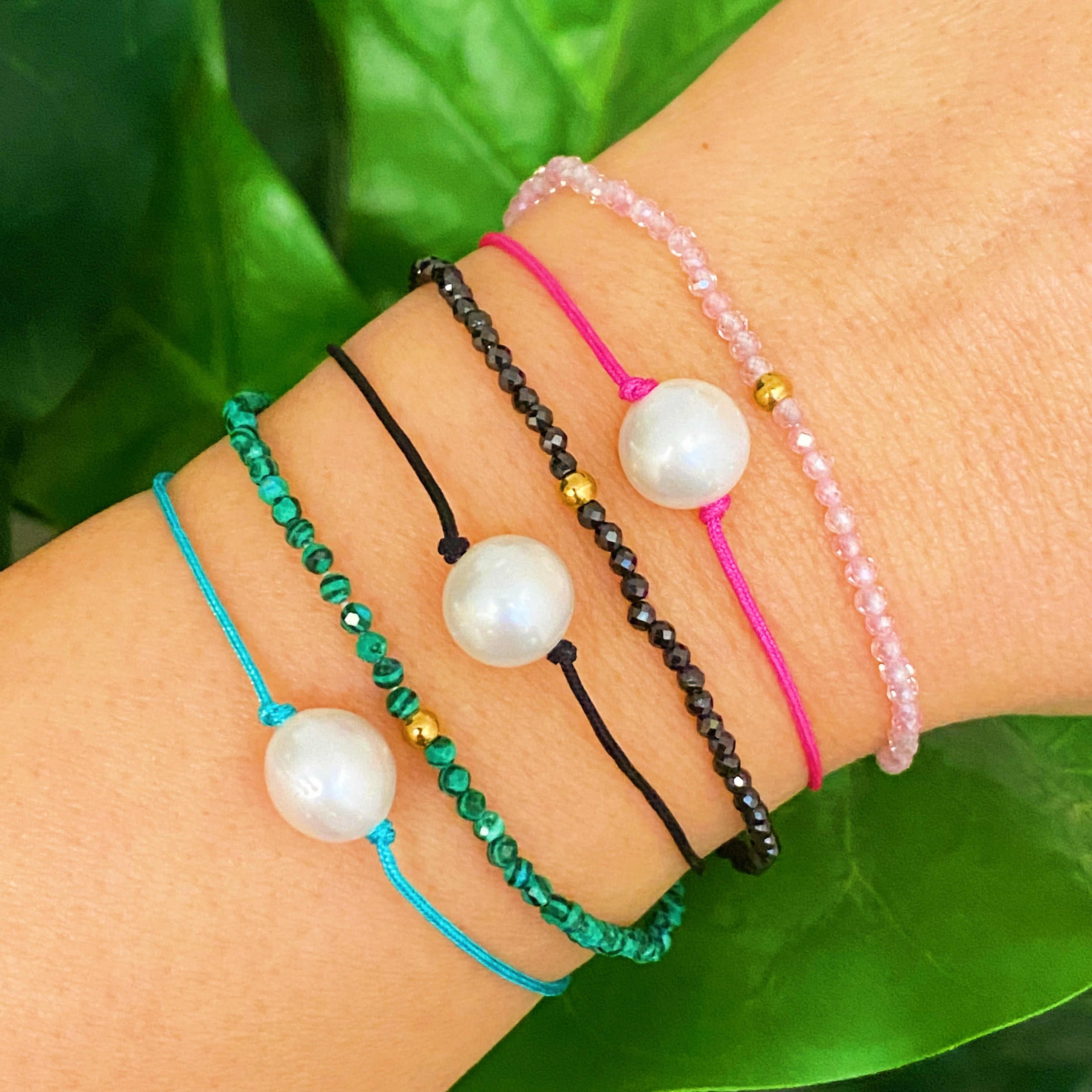 Genuine Pearl Color Dream Bracelet Set of 2 featuring freshwater pearls, colorful threads, and sparkly glass beads, elegantly displayed with a cream velvet bow.