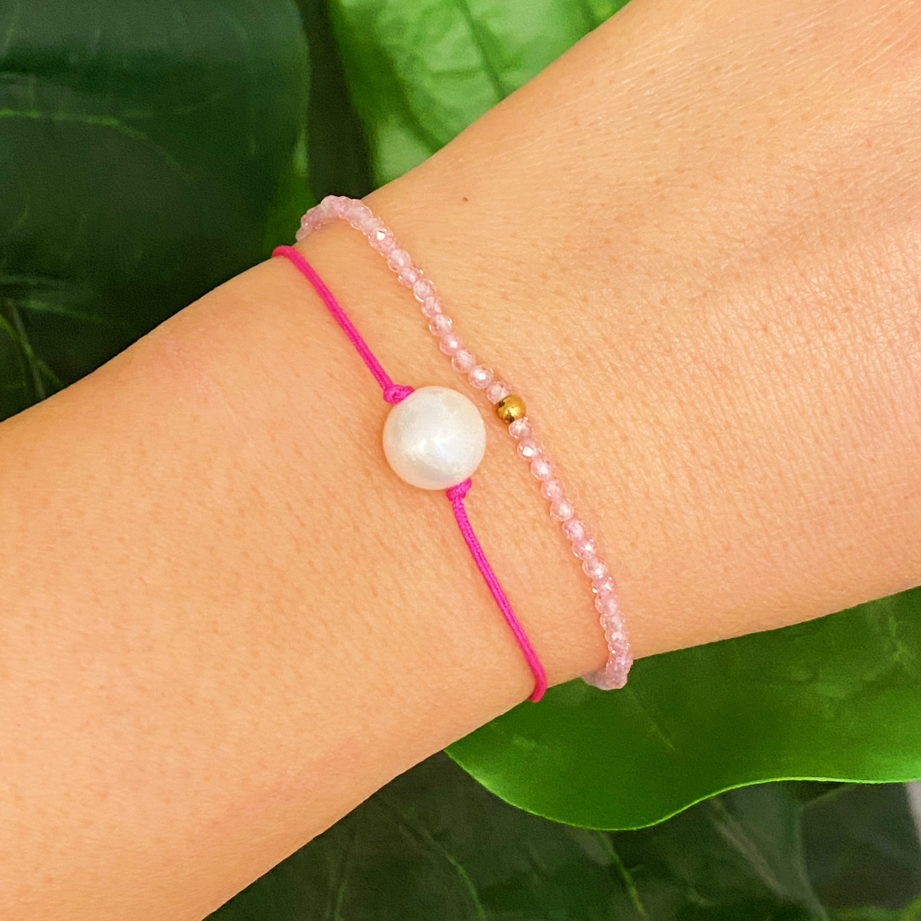 Genuine Pearl Color Dream Bracelet Set of 2 featuring freshwater pearls, colorful threads, and sparkly glass beads, elegantly displayed with a cream velvet bow.