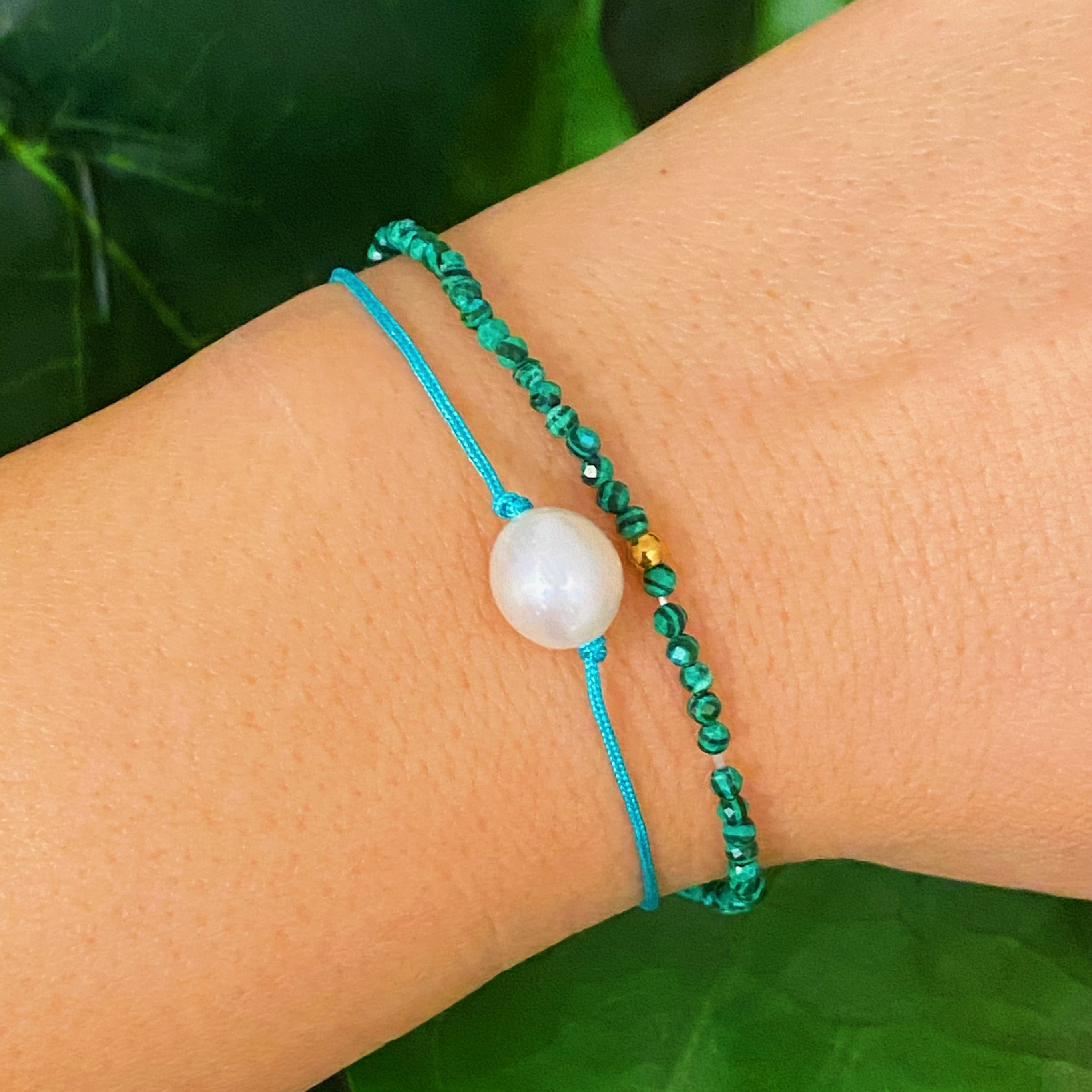 Genuine Pearl Color Dream Bracelet Set of 2 featuring freshwater pearls, colorful threads, and sparkly glass beads, elegantly displayed with a cream velvet bow.