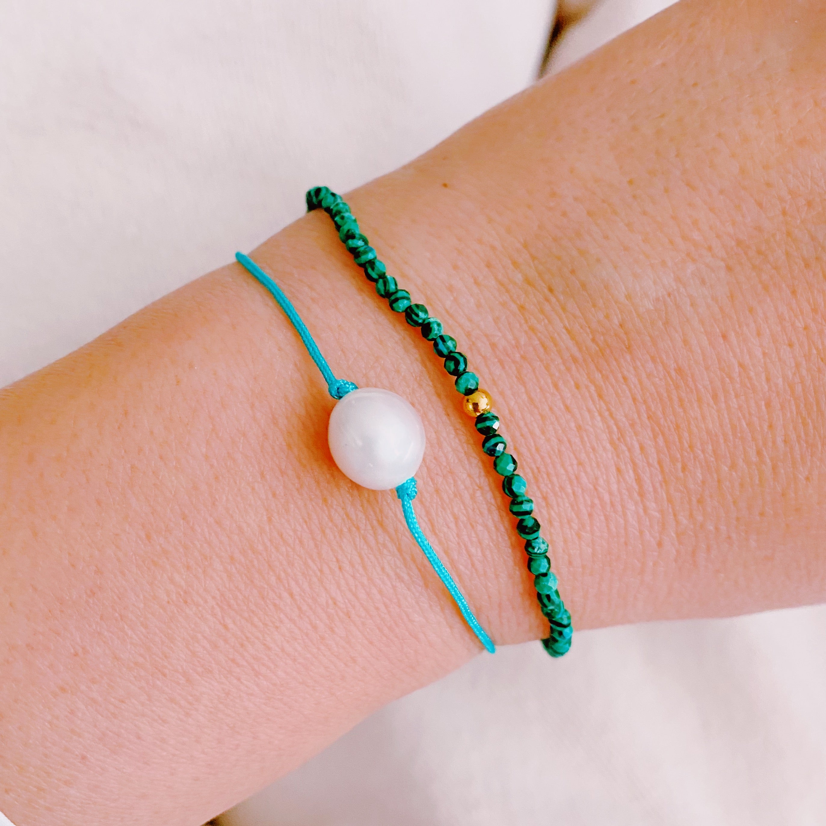 Genuine Pearl Color Dream Bracelet Set of 2 featuring freshwater pearls, colorful threads, and sparkly glass beads, elegantly displayed with a cream velvet bow.