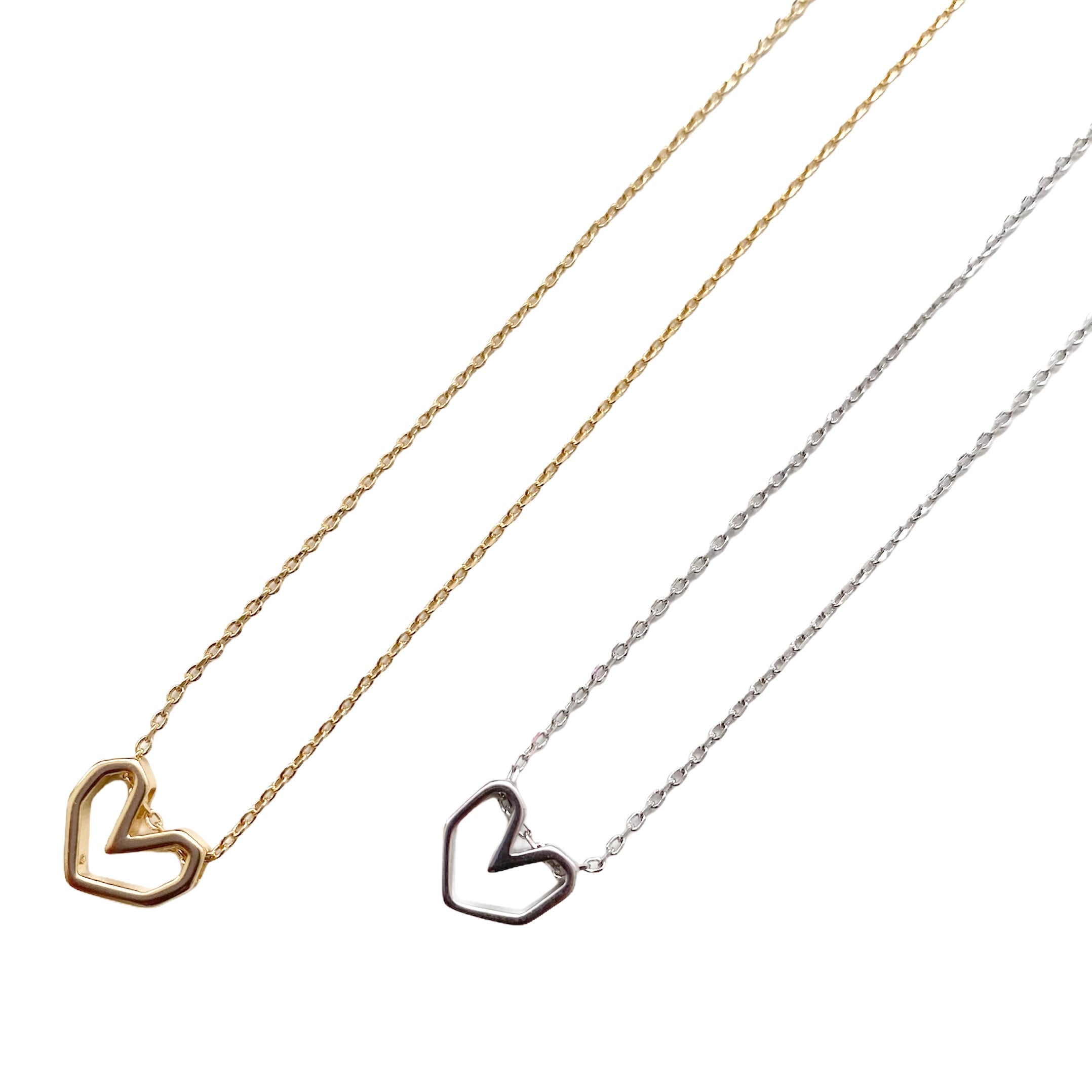 Geo Heart Dainty Necklace featuring a 3D geometric heart pendant in sterling silver, elegantly displayed on a soft background.