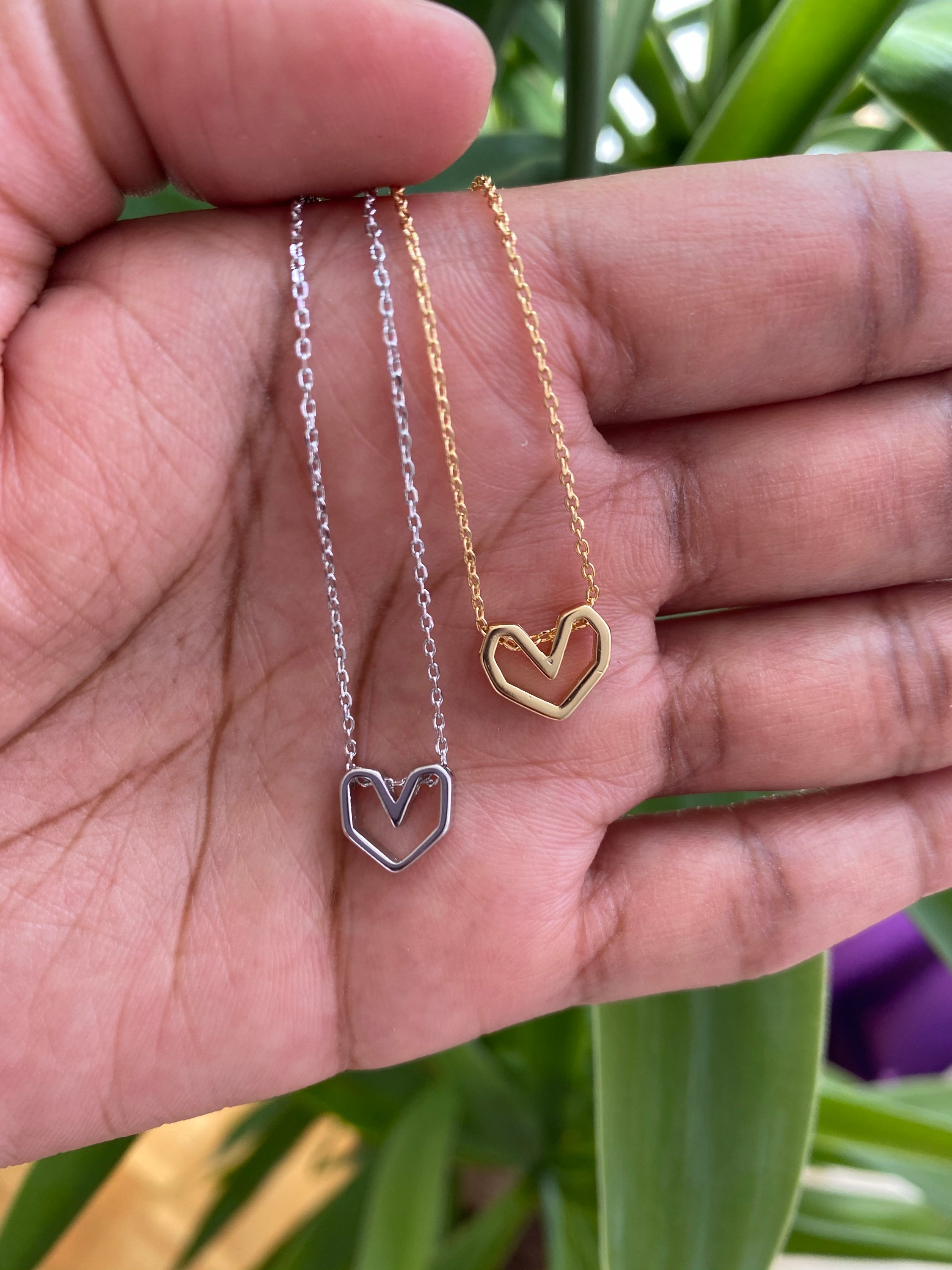 Geo Heart Dainty Necklace featuring a 3D geometric heart pendant in sterling silver, elegantly displayed on a soft background.