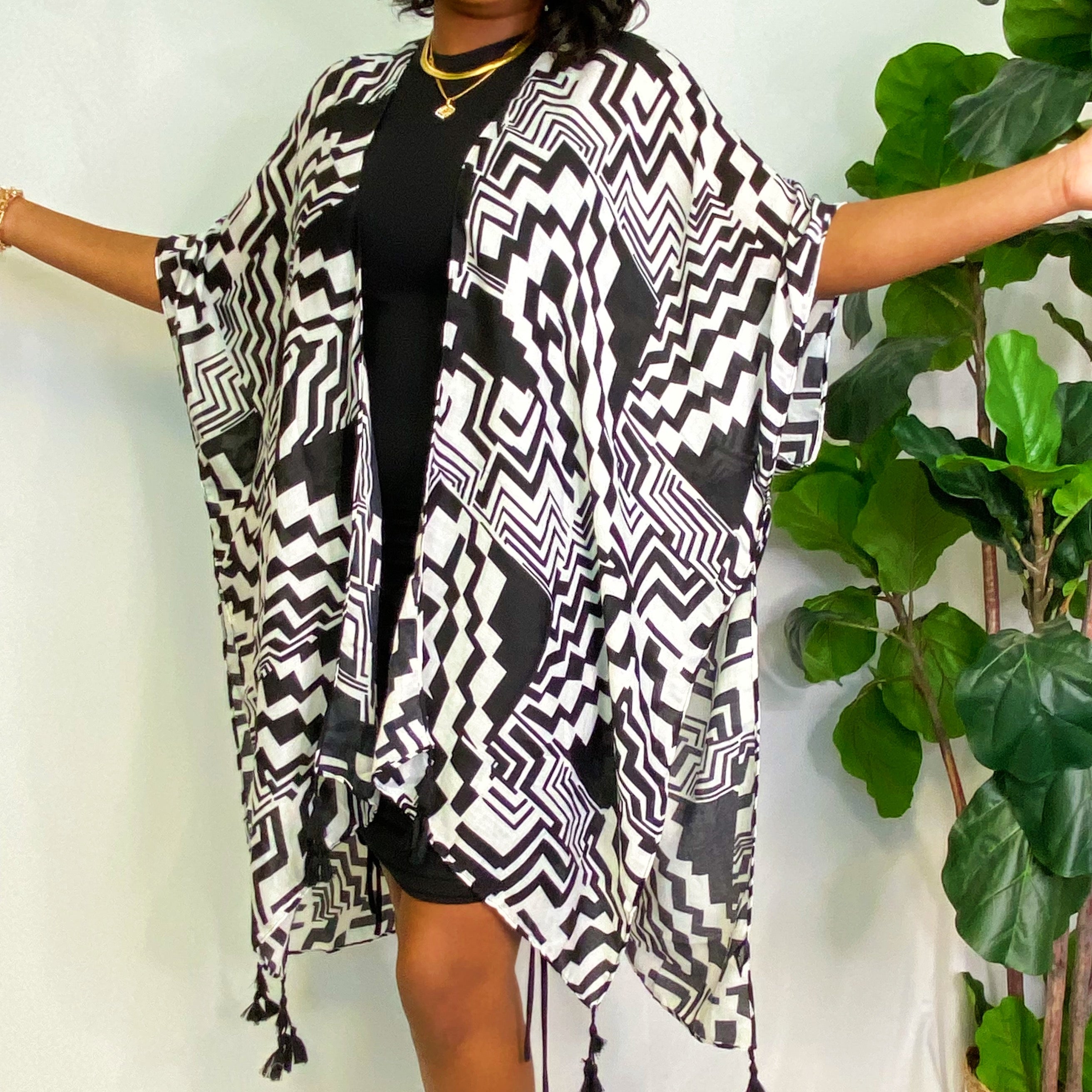 A stylish Geometric Art Kimono featuring an abstract print, lightweight and flowy, perfect for layering over outfits.