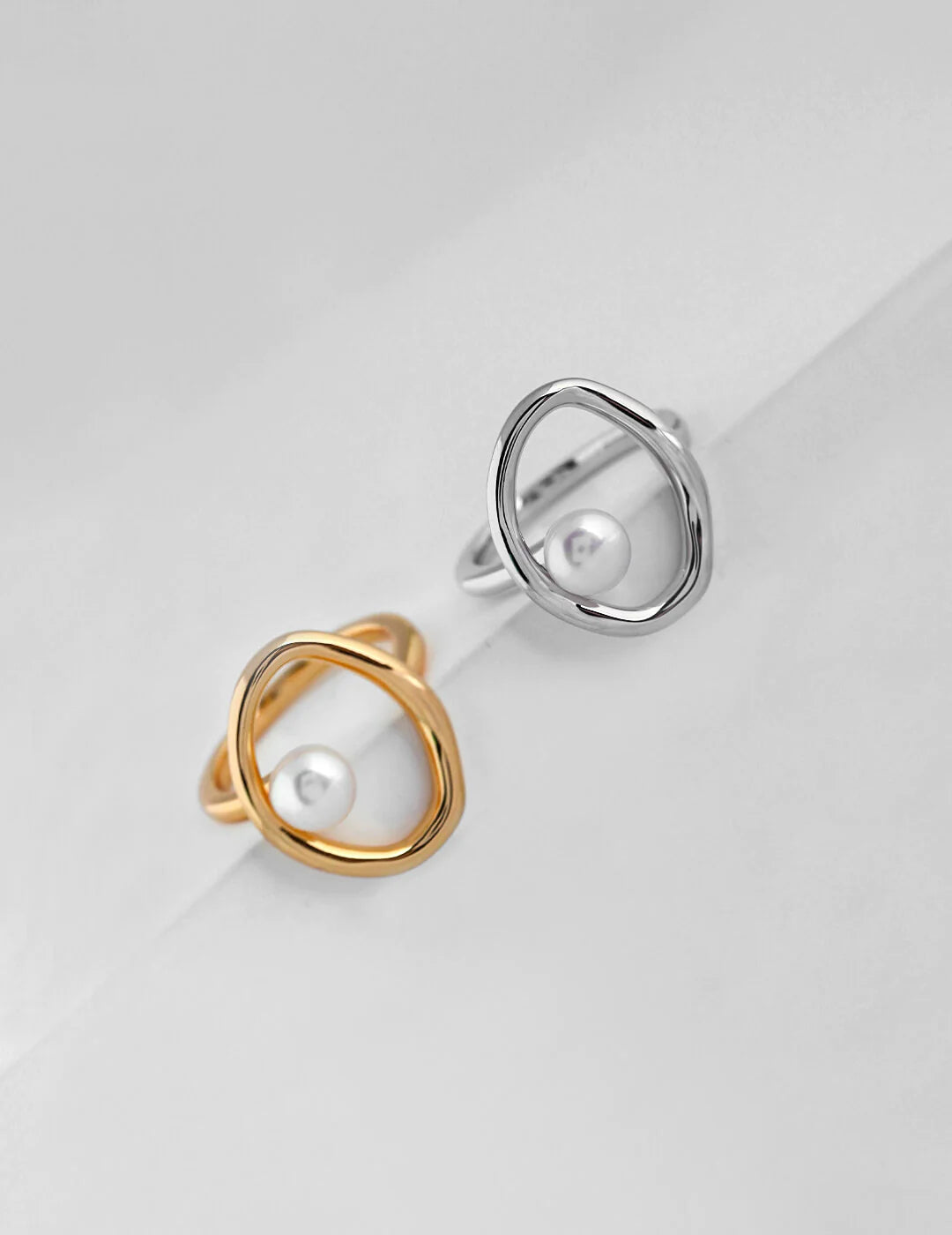 A beautifully handcrafted Geometric Open Circle Ring featuring natural pearls and sterling silver with gold vermeil plating.